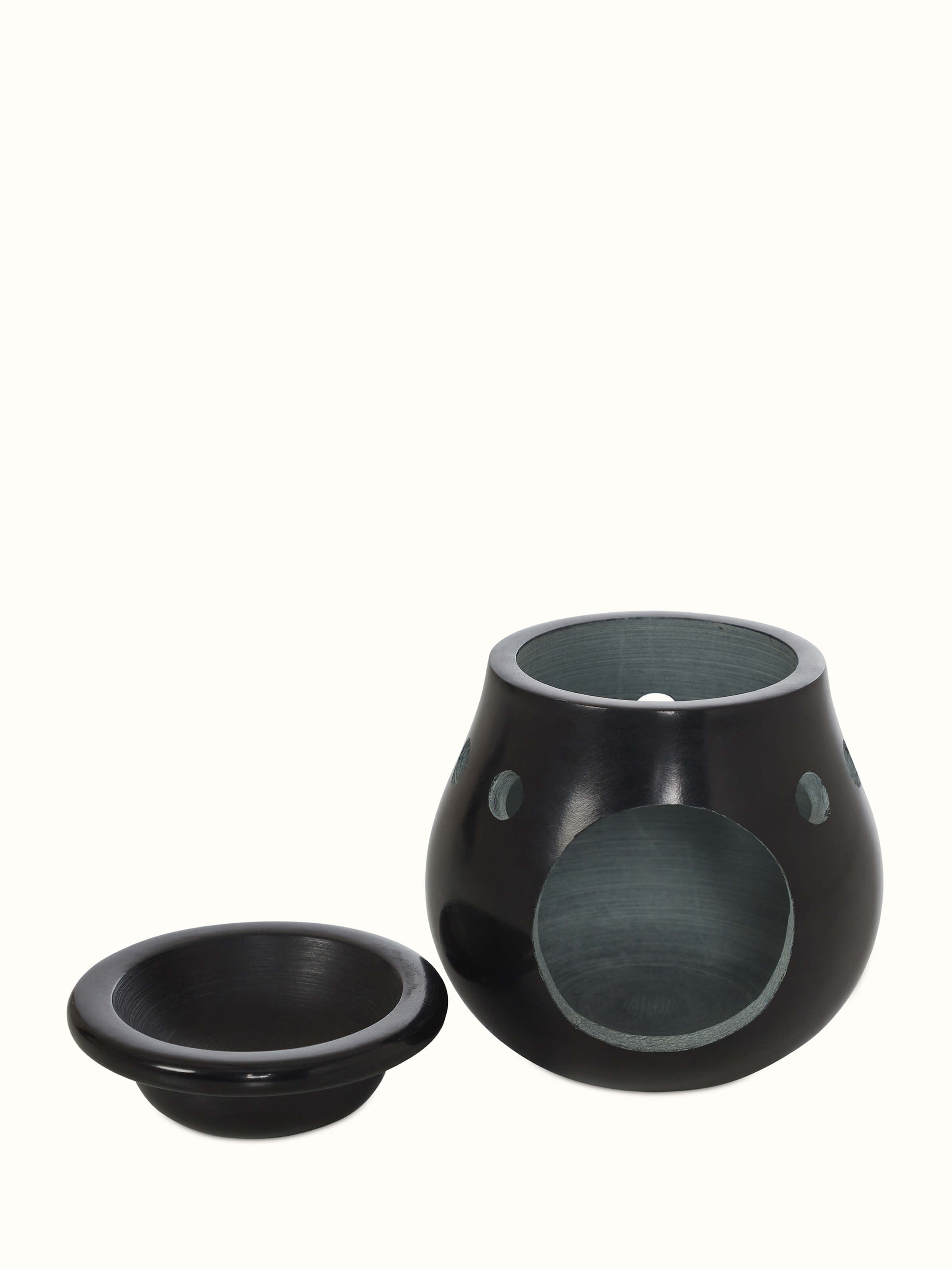 Front view of carved stone diffuser in black color, featuring an elegant and intricate stone design