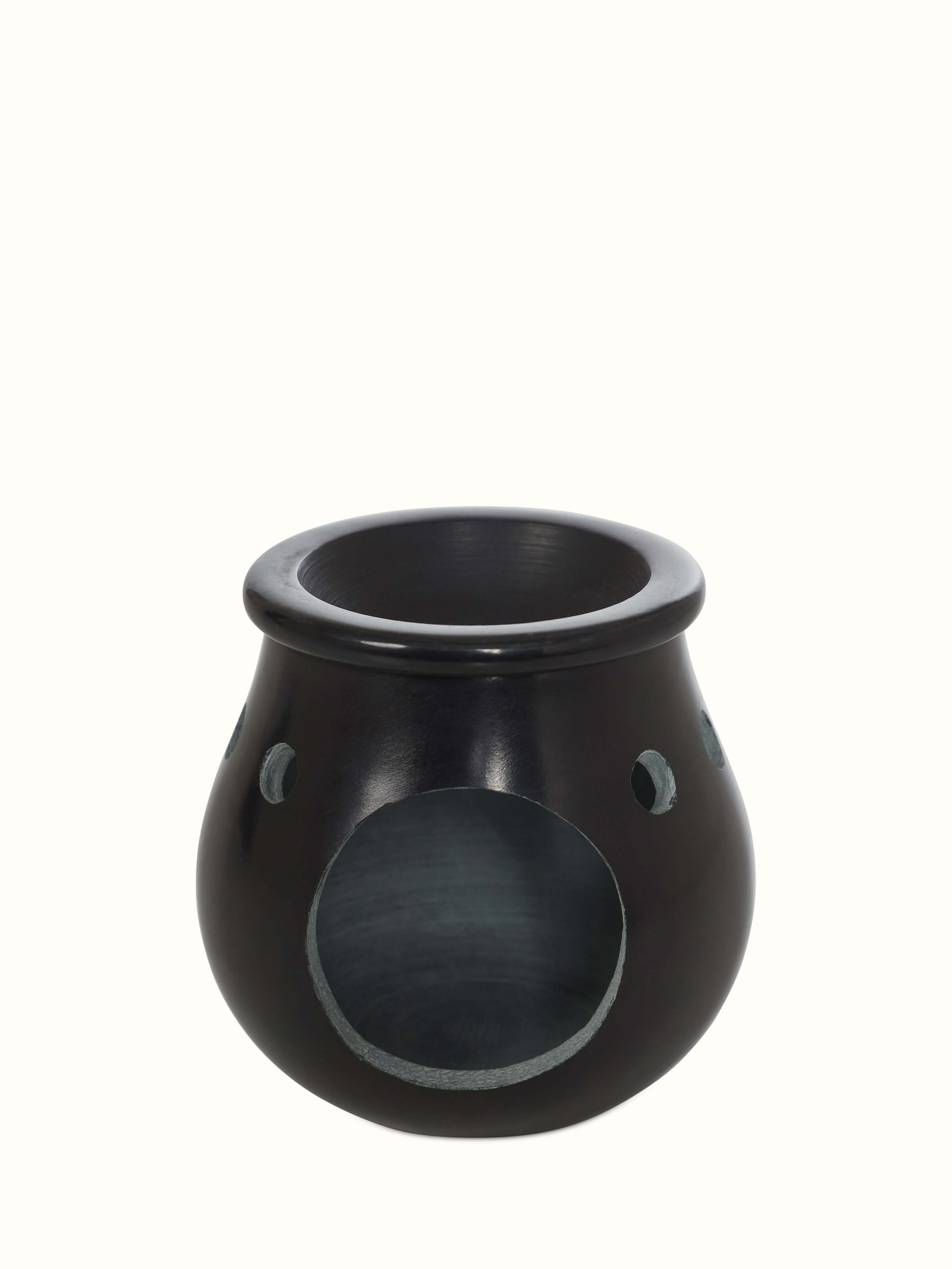 Close-up of carved stone diffuser in black color, showcasing the fine craftsmanship and texture of the stone