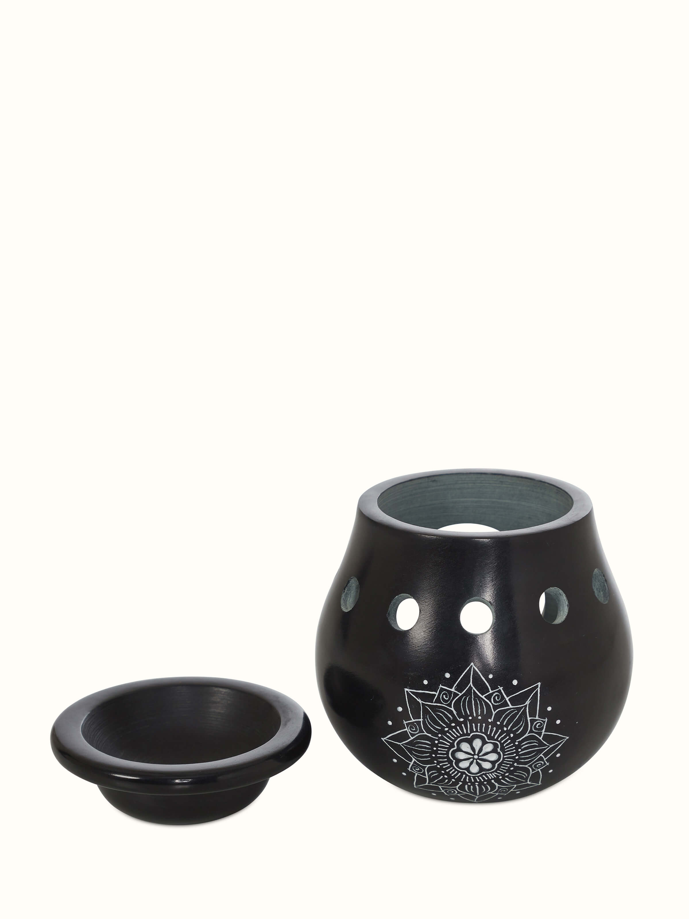 Artistic view of carved stone diffuser in black color, highlighting the elegant design and functionality