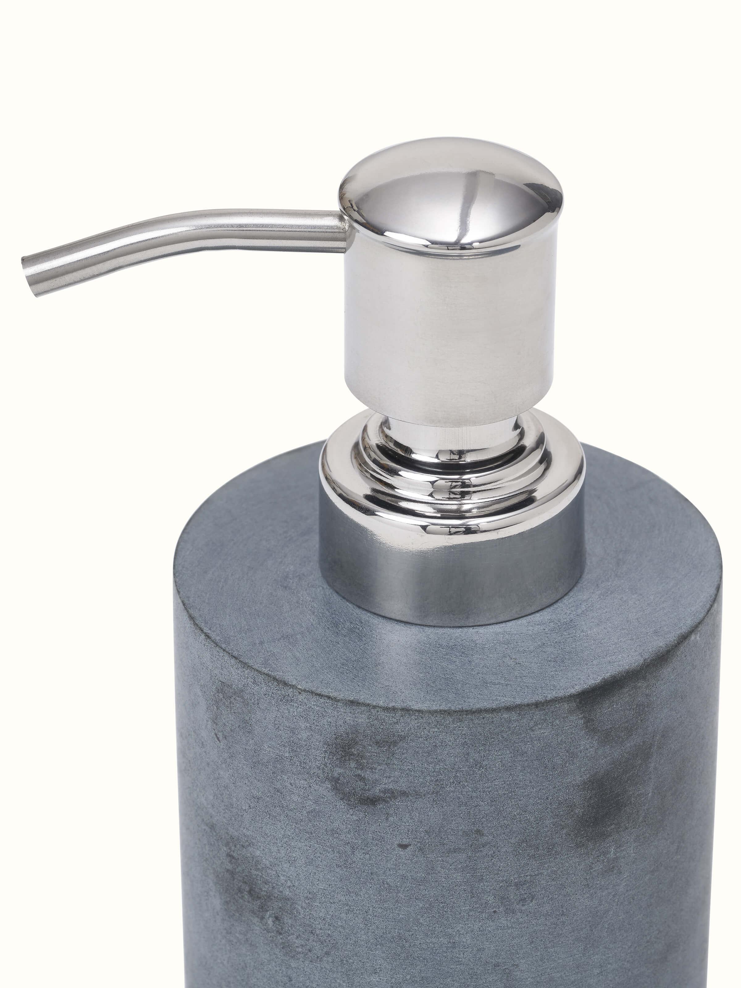 Angled view of glossy carved stone soap dispenser showcasing its stylish design and intricate carving work.