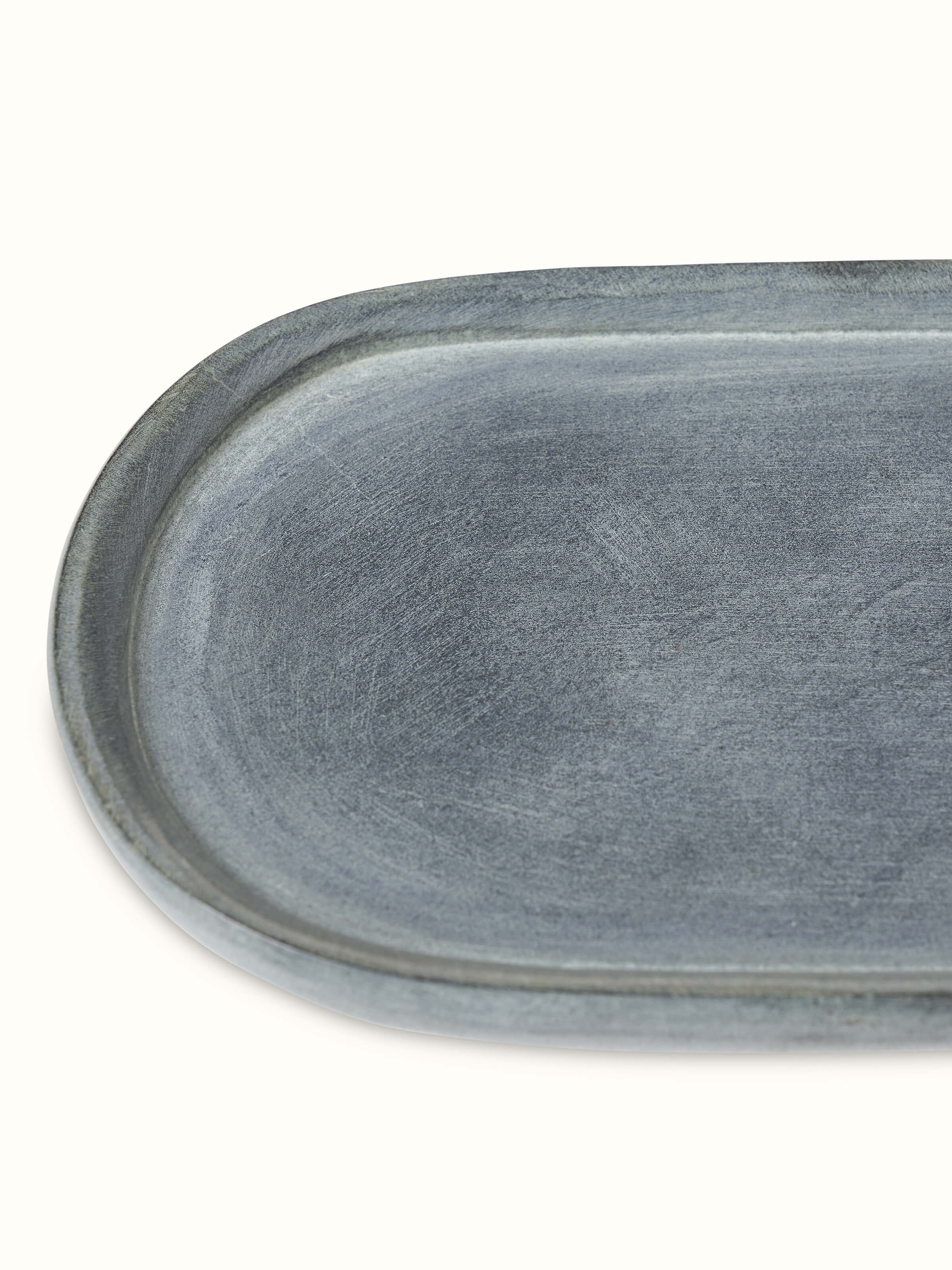 Side view of natural carved stone bath tray, emphasizing the craftsmanship and stone's natural finish.