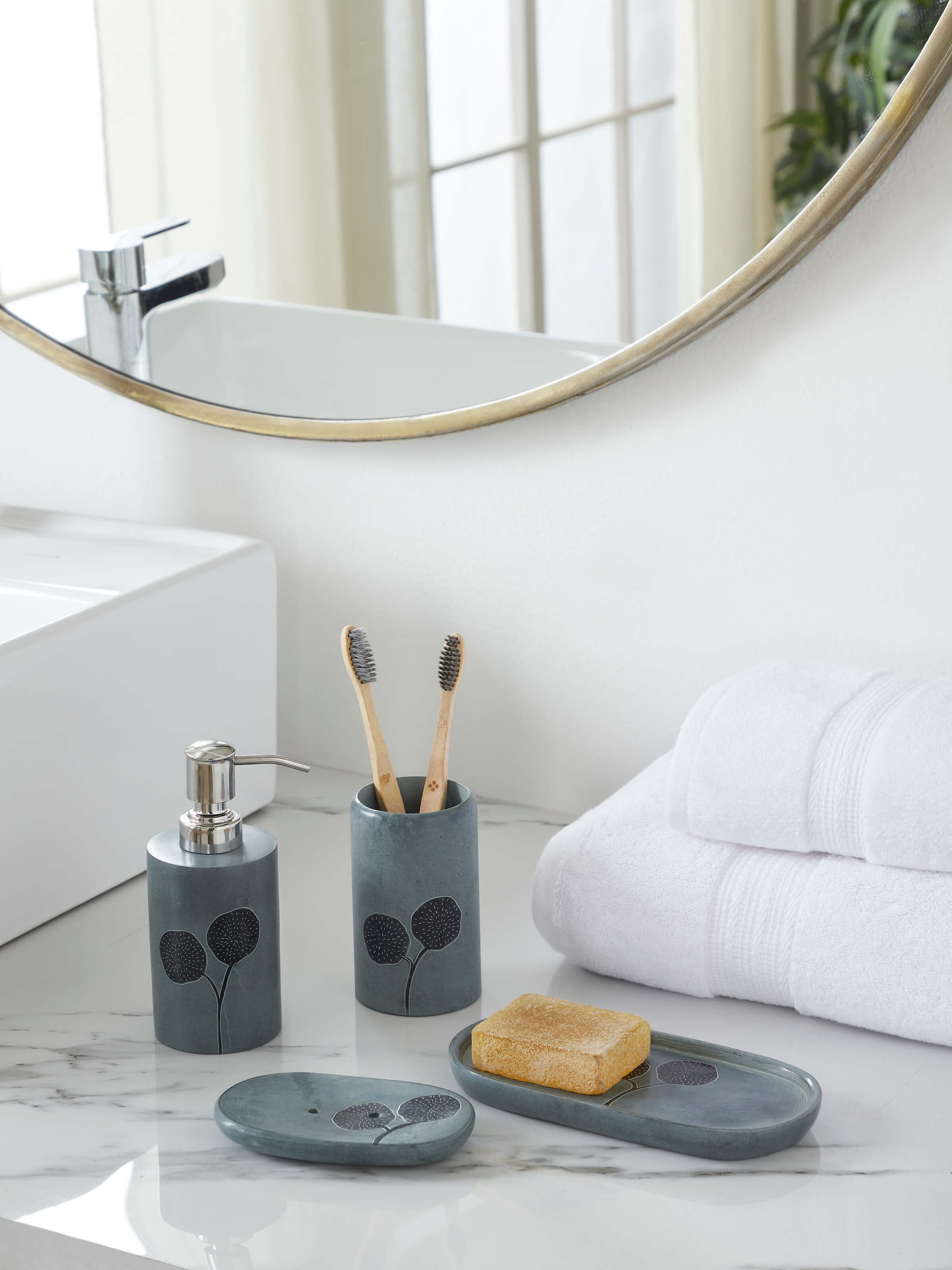 Side view of Carved stone toothbrush holder with detailed carving