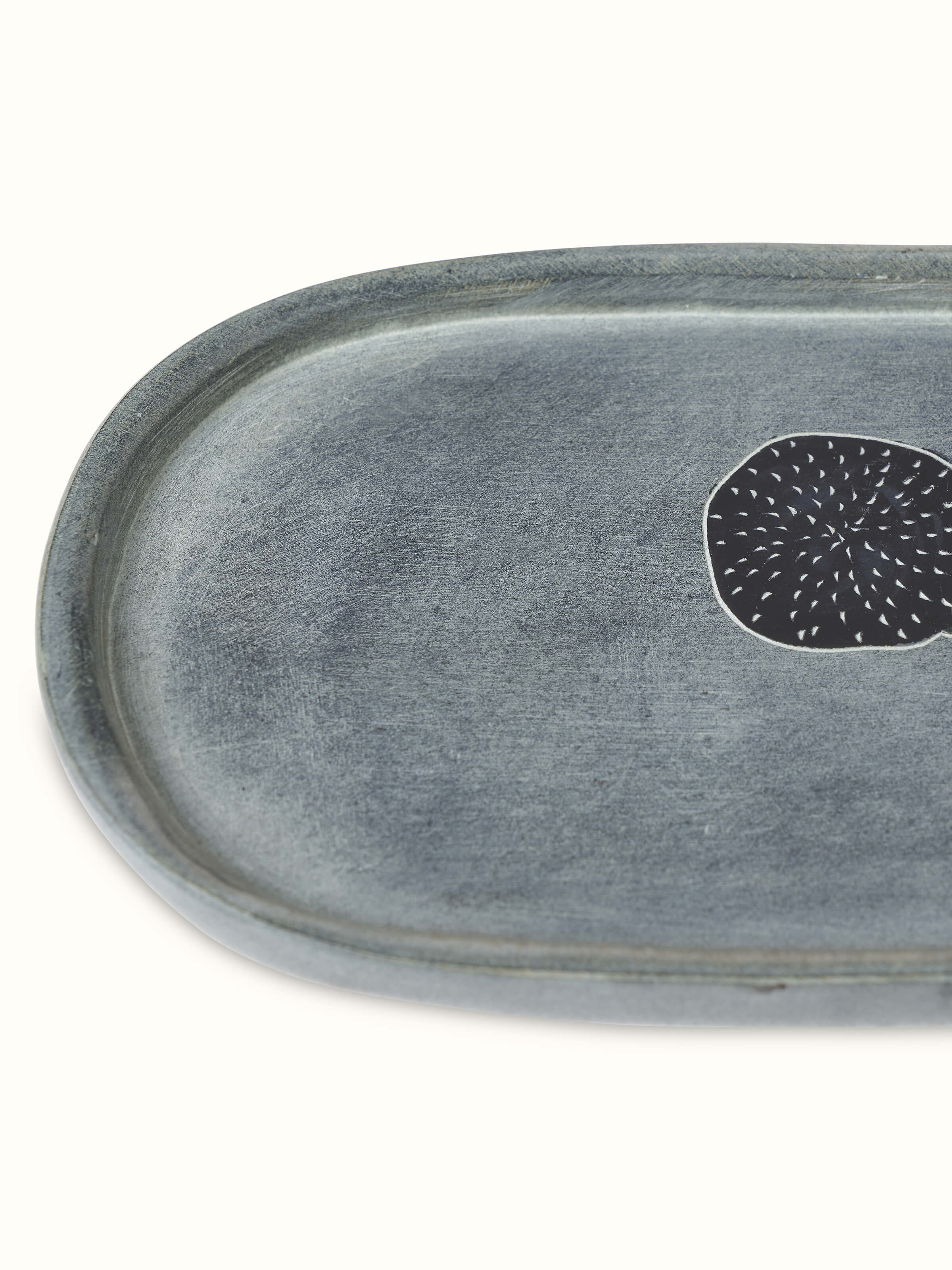 Angled view of Glossy Carved Stone Bath Tray, providing a detailed view of the carving and overall shape