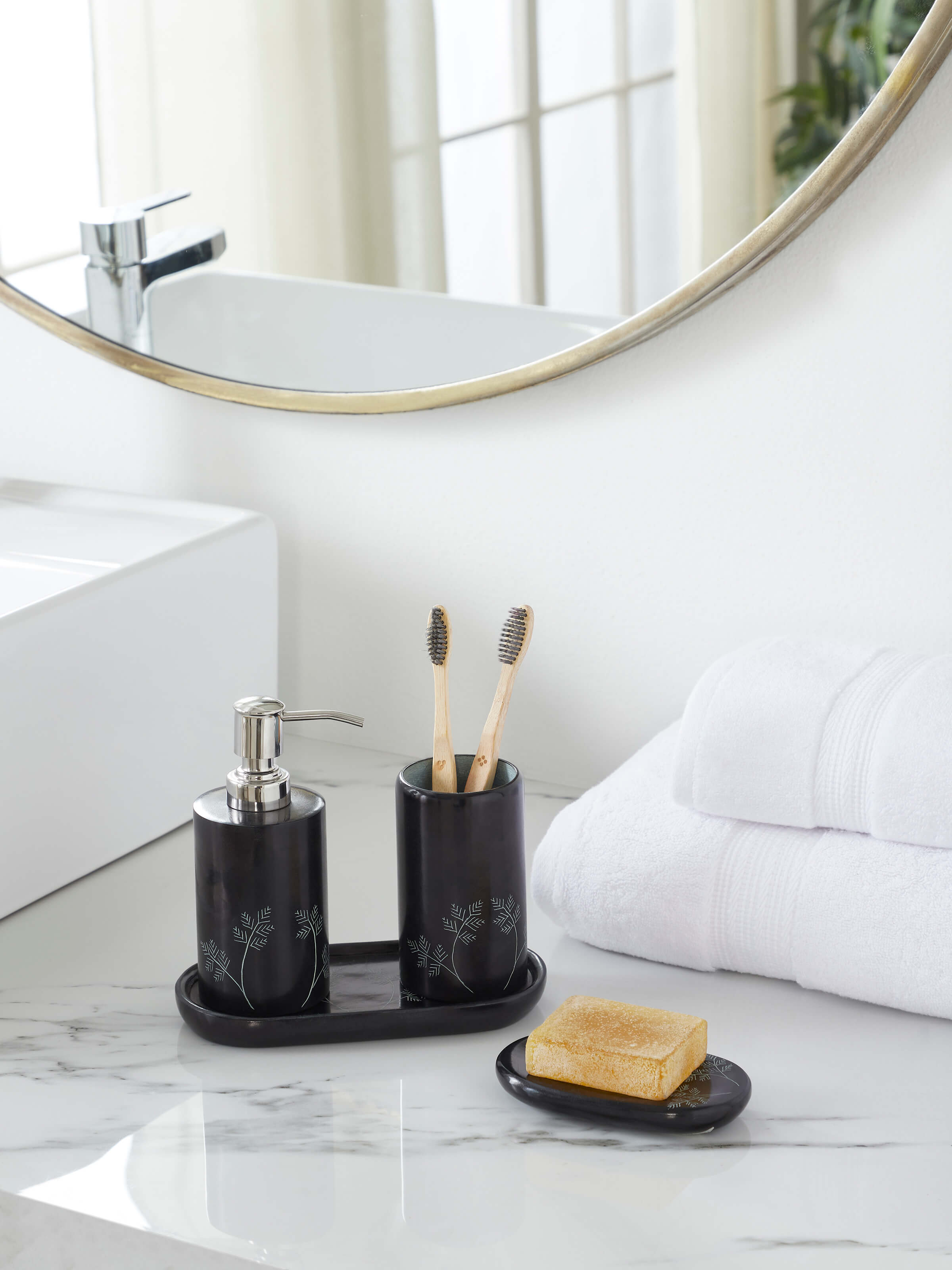 Side view of glossy carved stone toothbrush holder emphasizing the polished surface and design