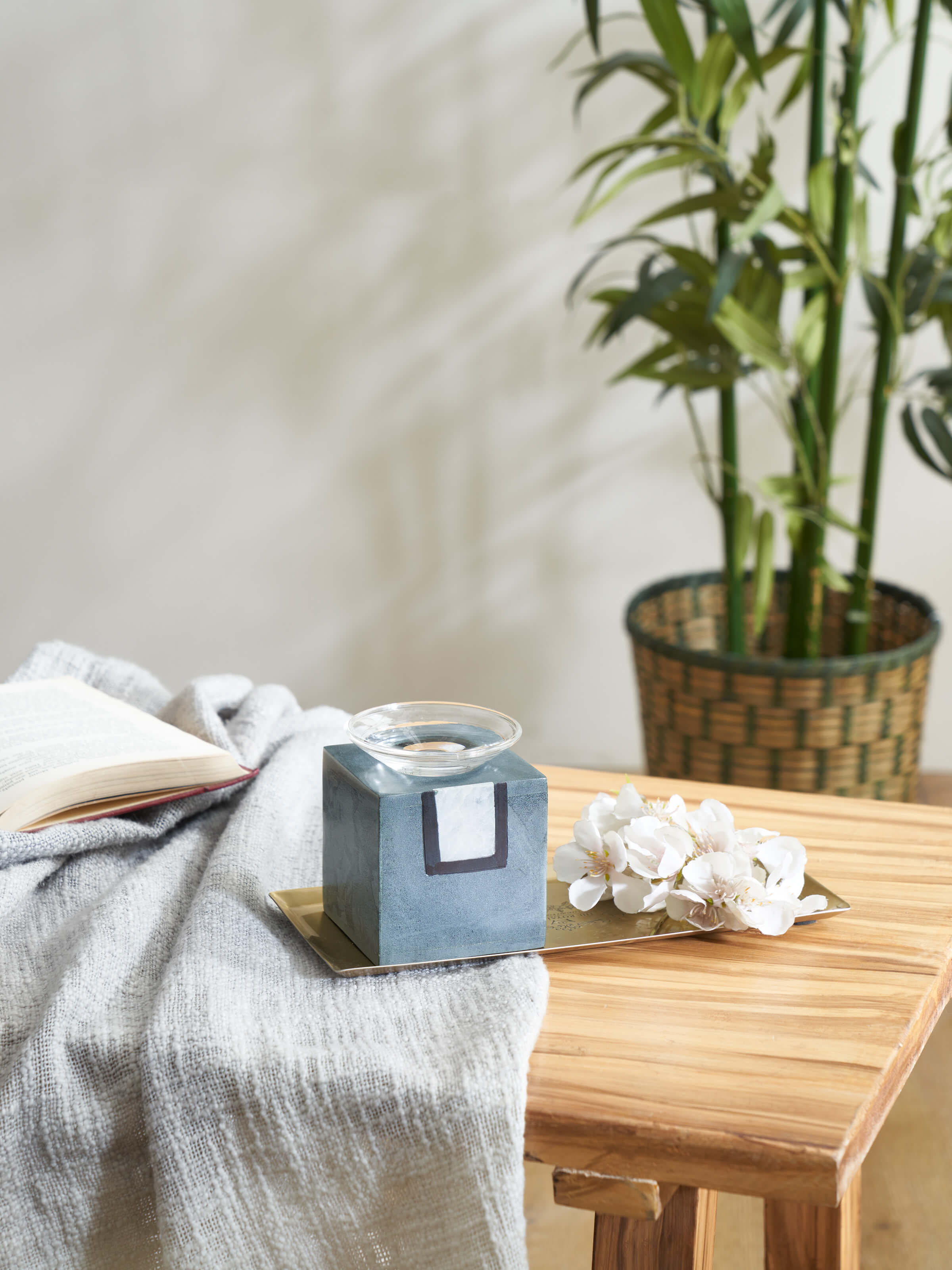 Side view of Carved stone diffuser in grey color highlighting its sleek profile and carved details