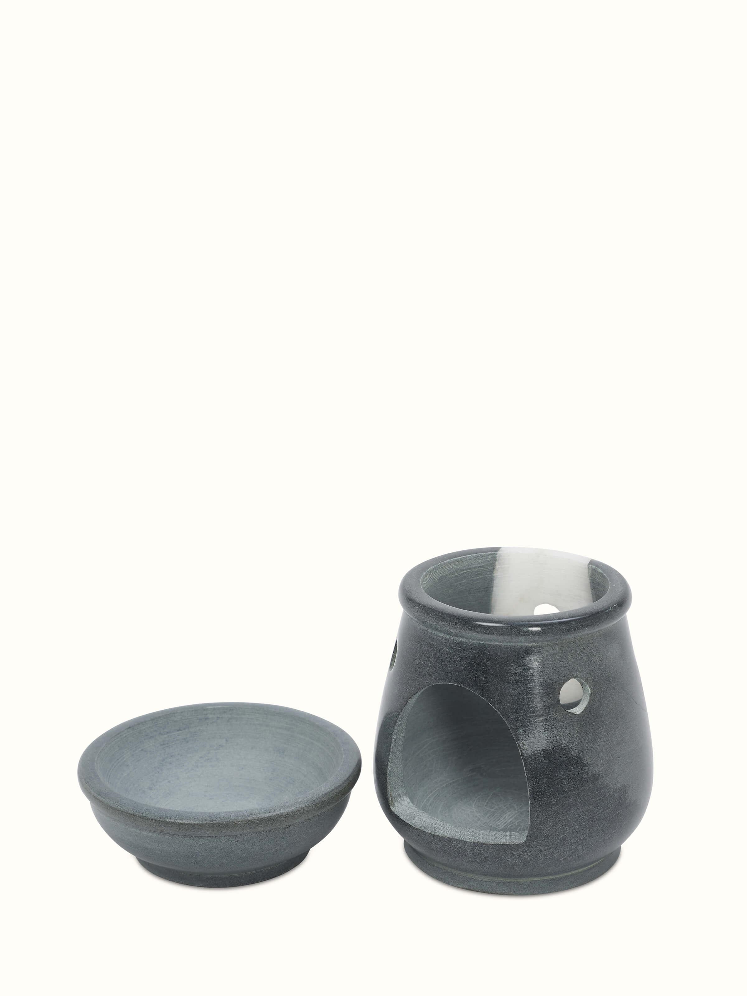 Front view of Traditional carved stone diffuser showcasing intricate carvings.