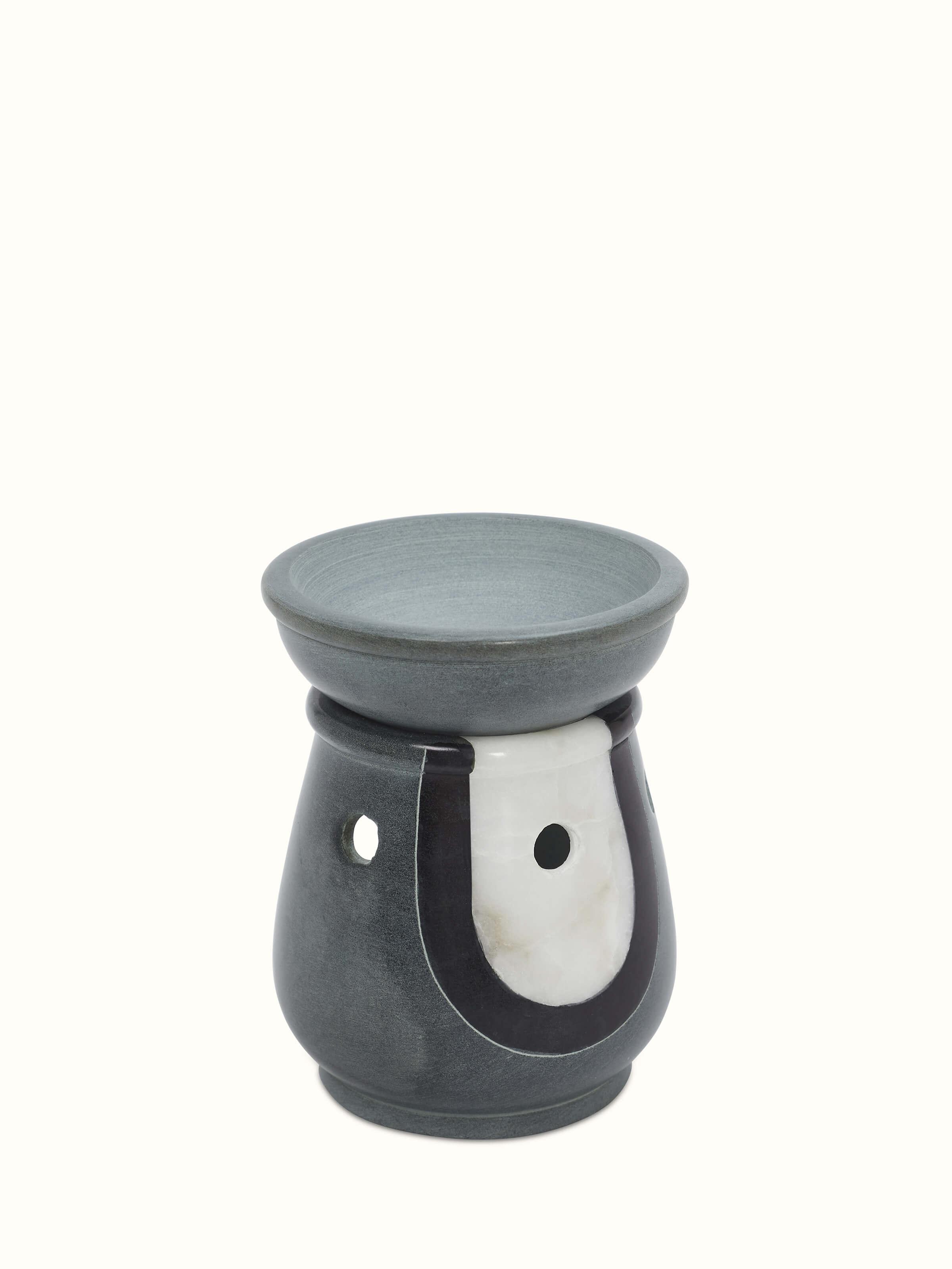 Side view of Traditional carved stone diffuser highlighting its detailed artistry.
