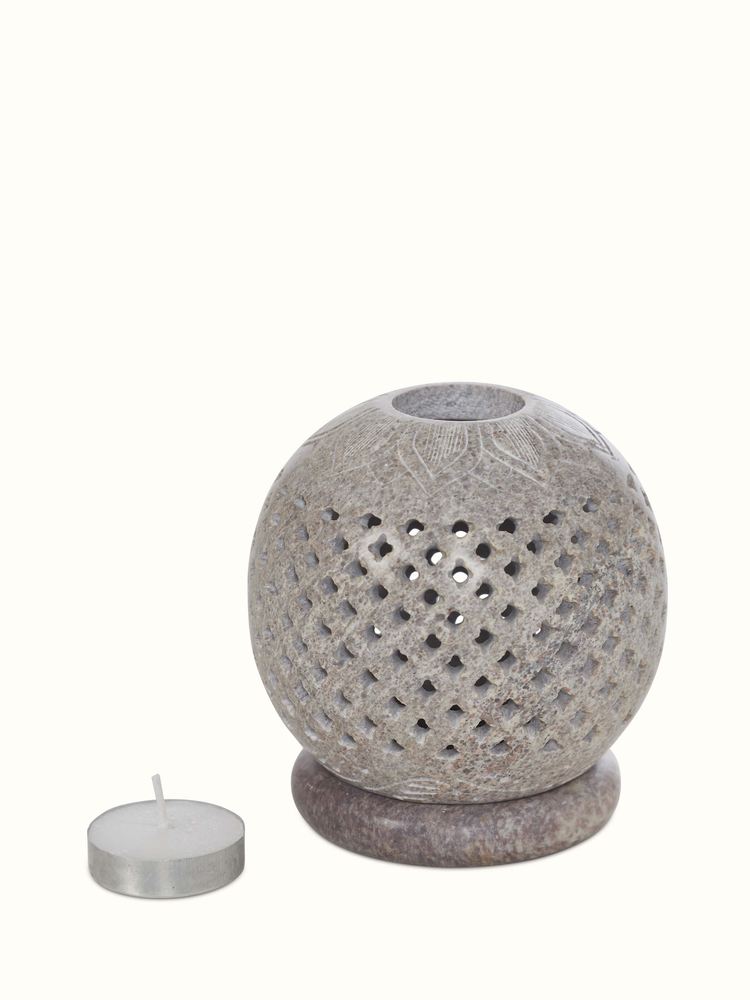 Detailed view of carved stone tea light holder, highlighting the texture and craftsmanship