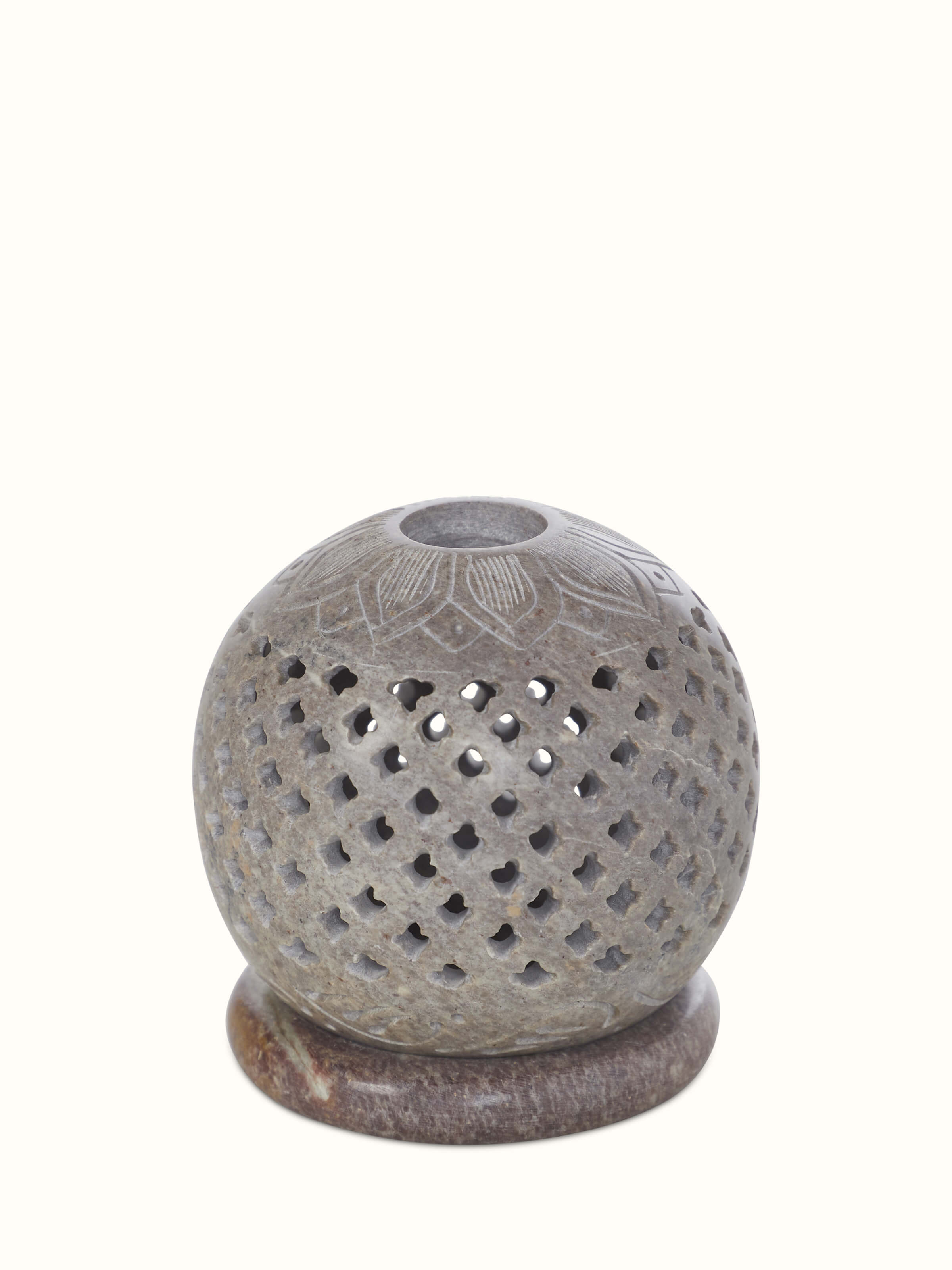 Natural carved stone tea light holder with detailed patterns and a polished finish.