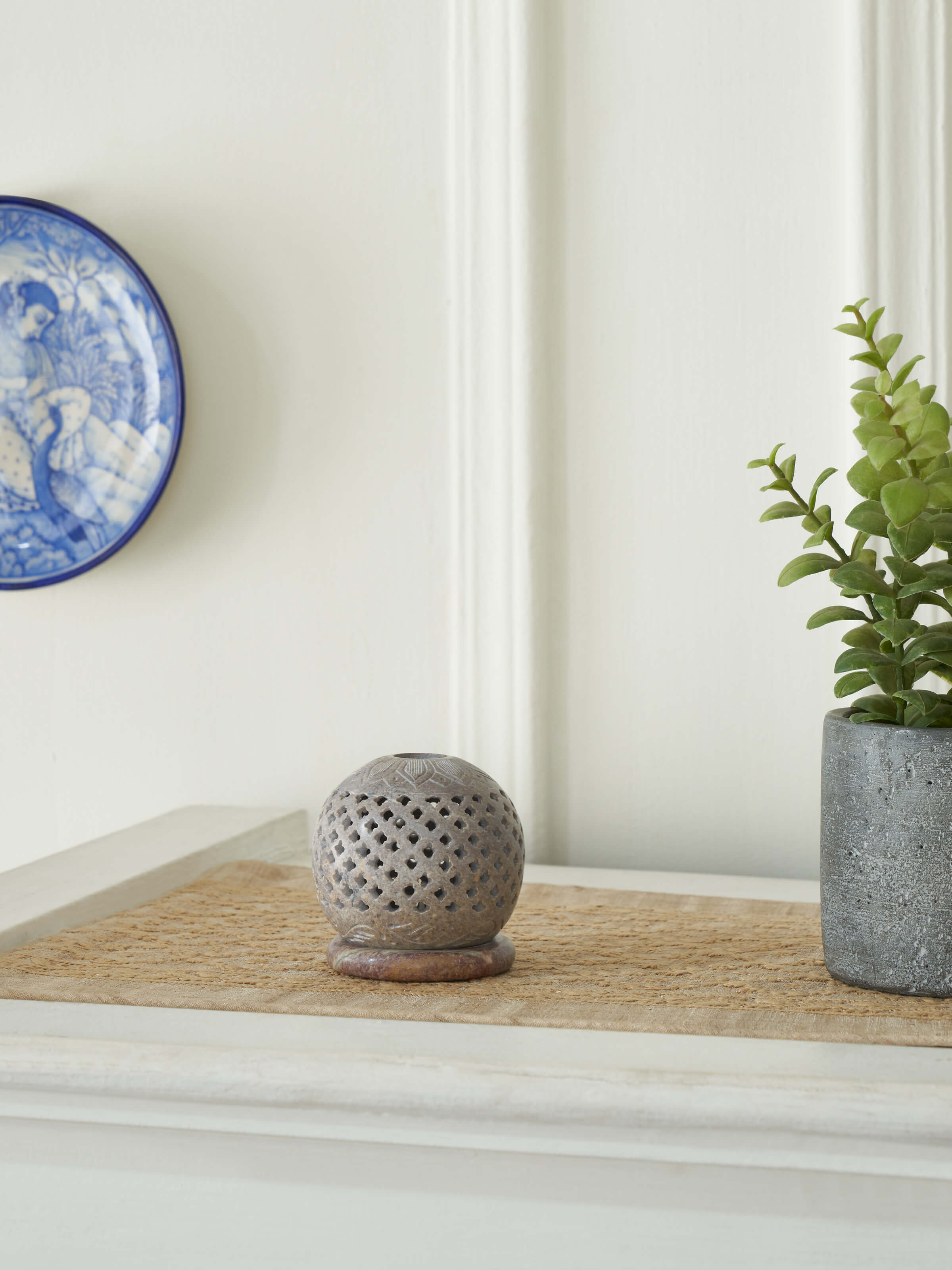 Close-up view of natural carved stone tea light holder, showcasing its intricate carving and elegant design.