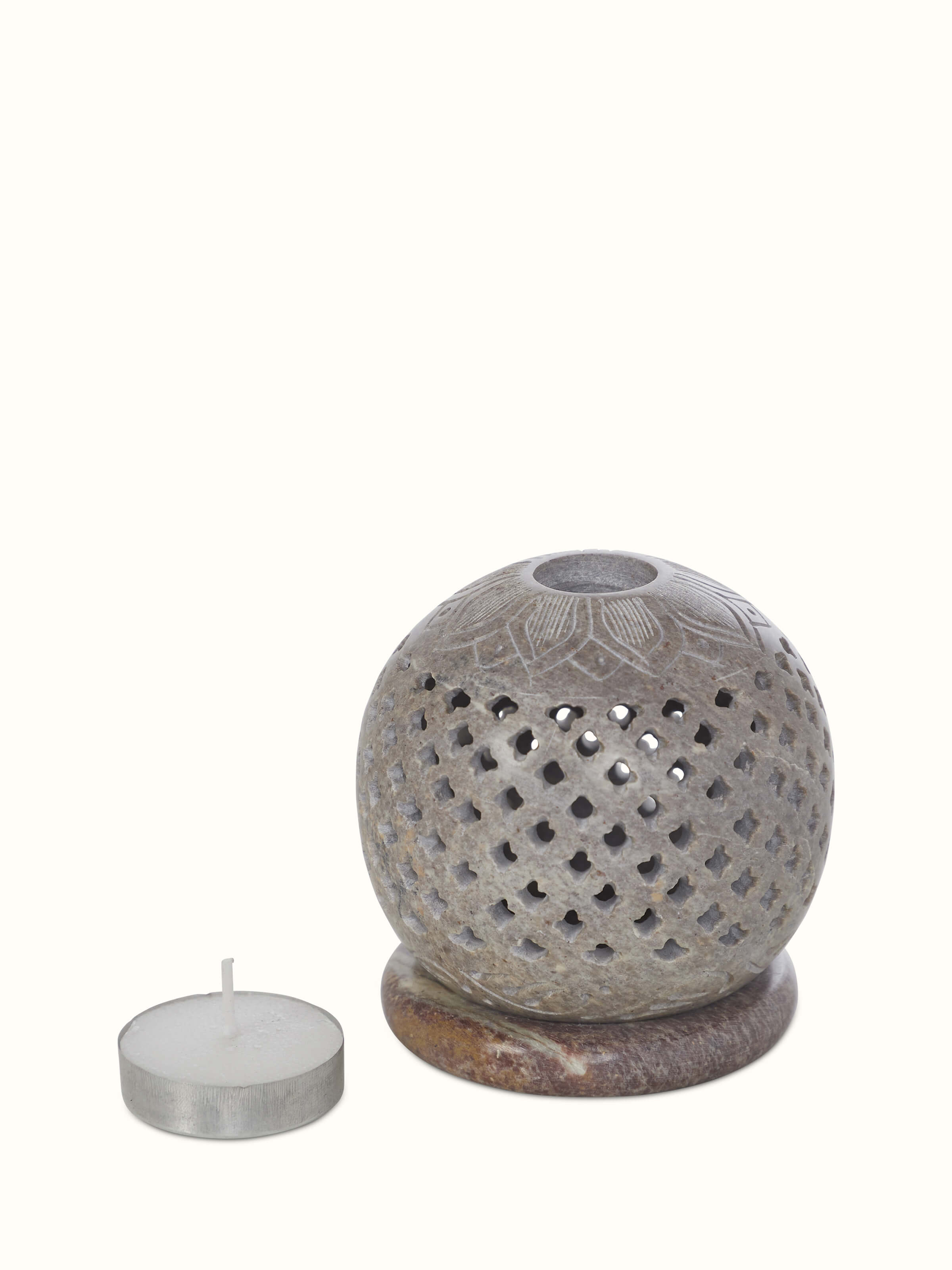 Side view of natural carved stone tea light holder, highlighting its detailed craftsmanship and artistic design.