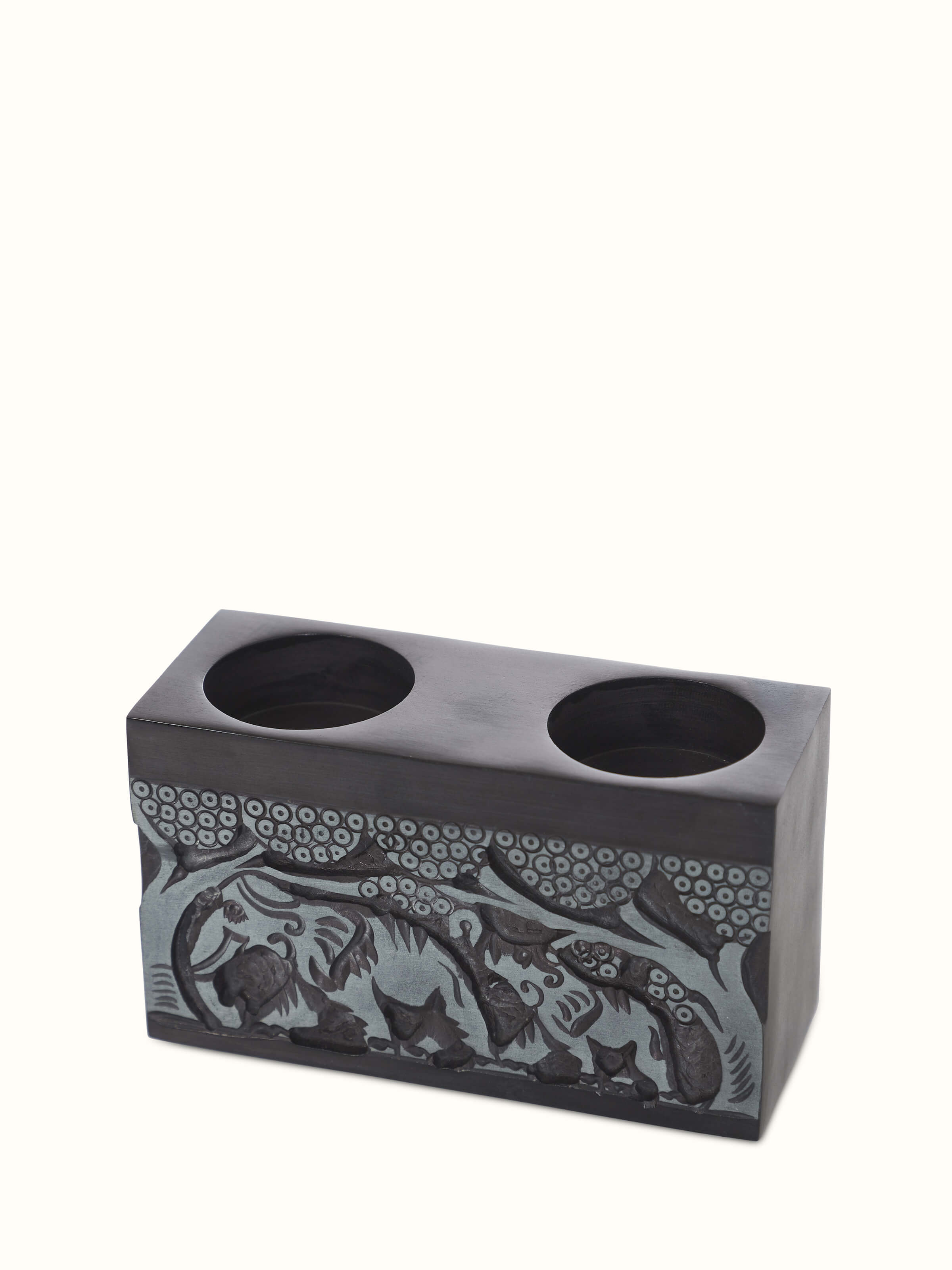 Close-up of Transitional Carved Stone Tea Light Holder, highlighting the texture and carved patterns in the stone.