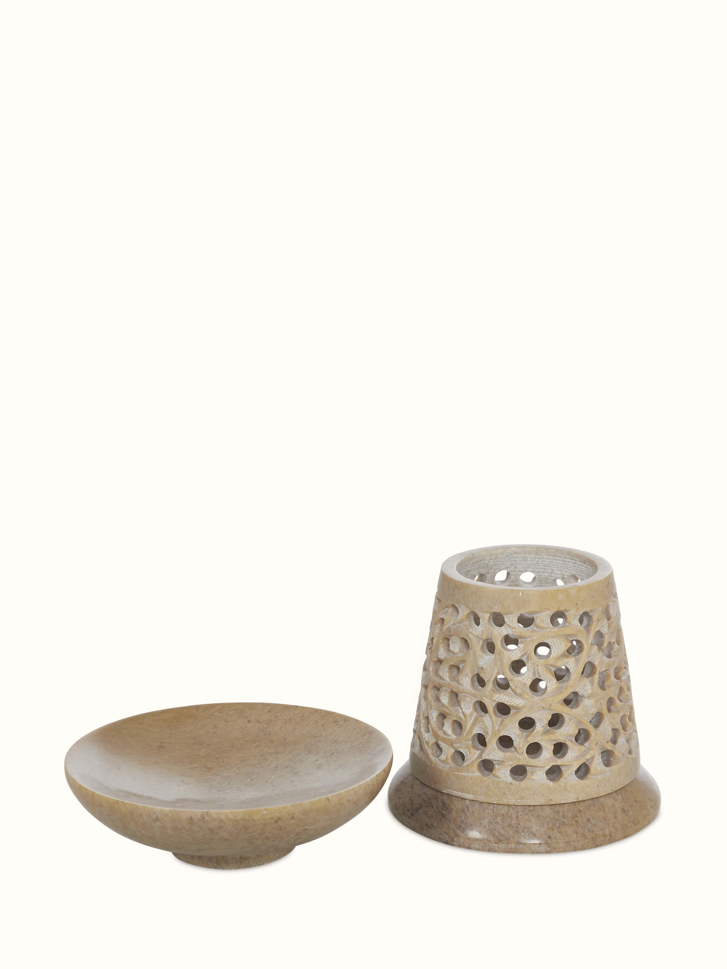 Angle view of polished carved stone diffuser showing the smooth transitional finish and artistic design