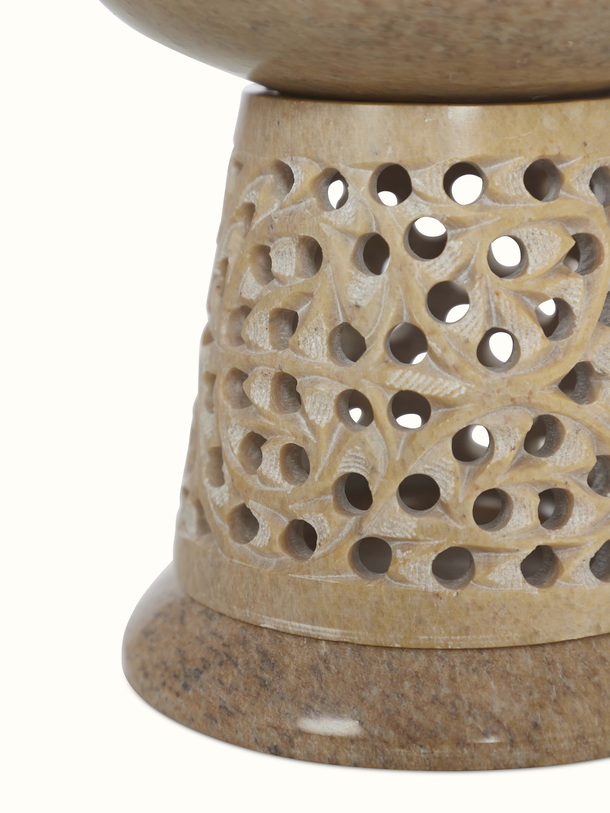 Top-down view of polished carved stone diffuser emphasizing the high-quality transitional polish