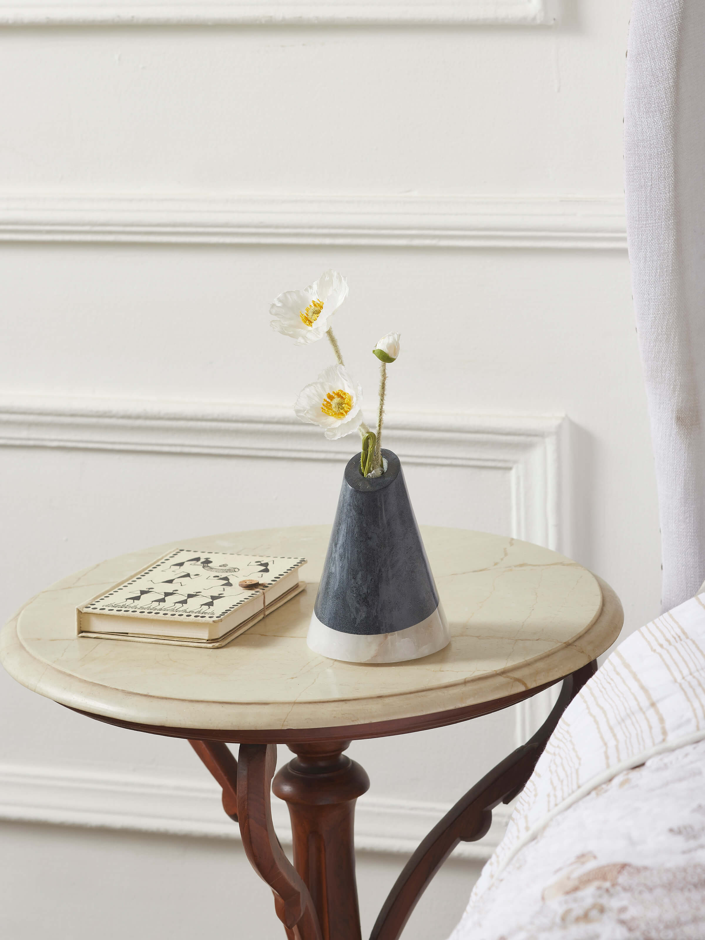 Side view of carved soapstone bud vase in black color showcasing its smooth finish
