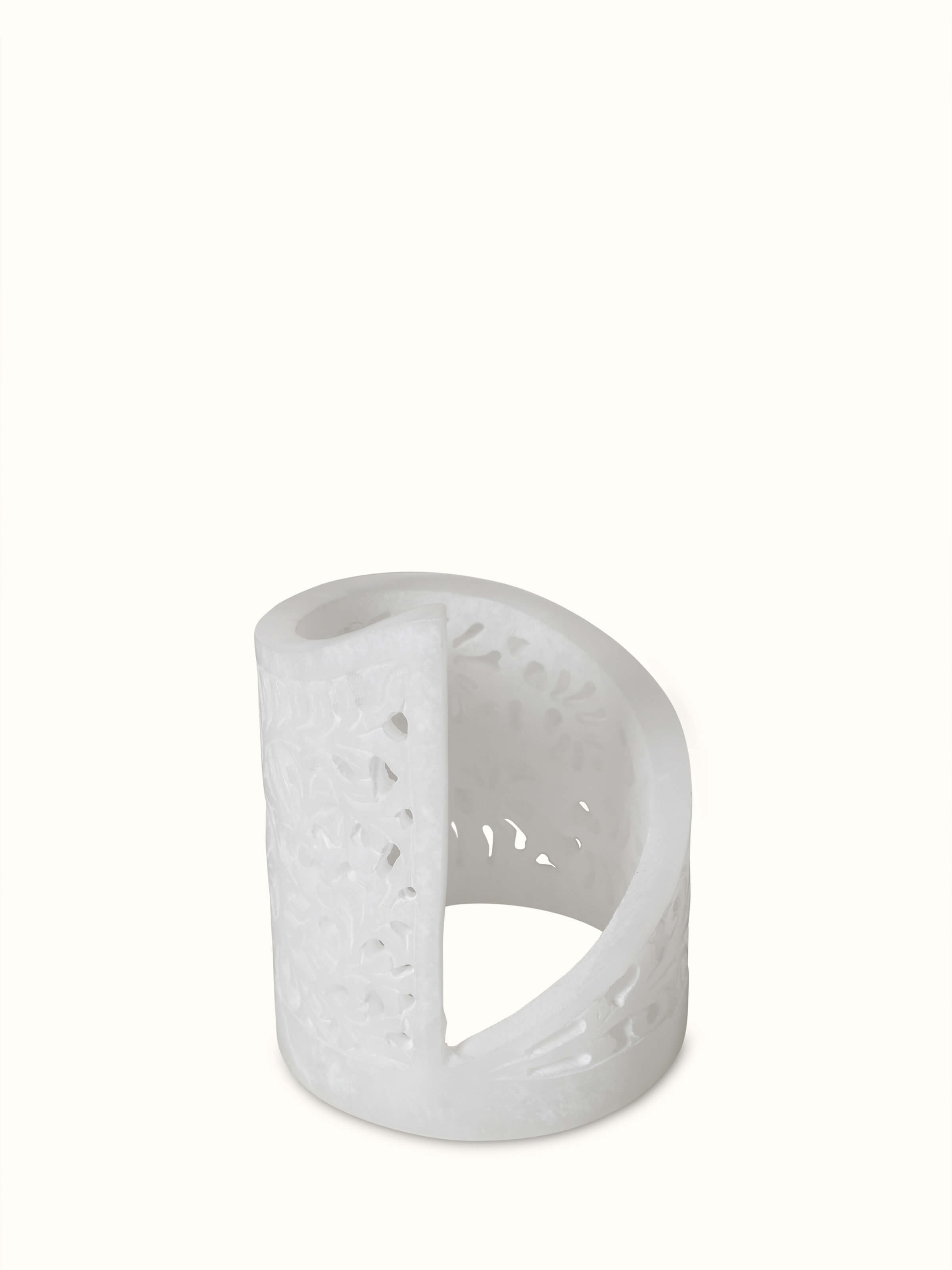 Polished carved soapstone tea light holder with intricate patterns and a smooth finish.
