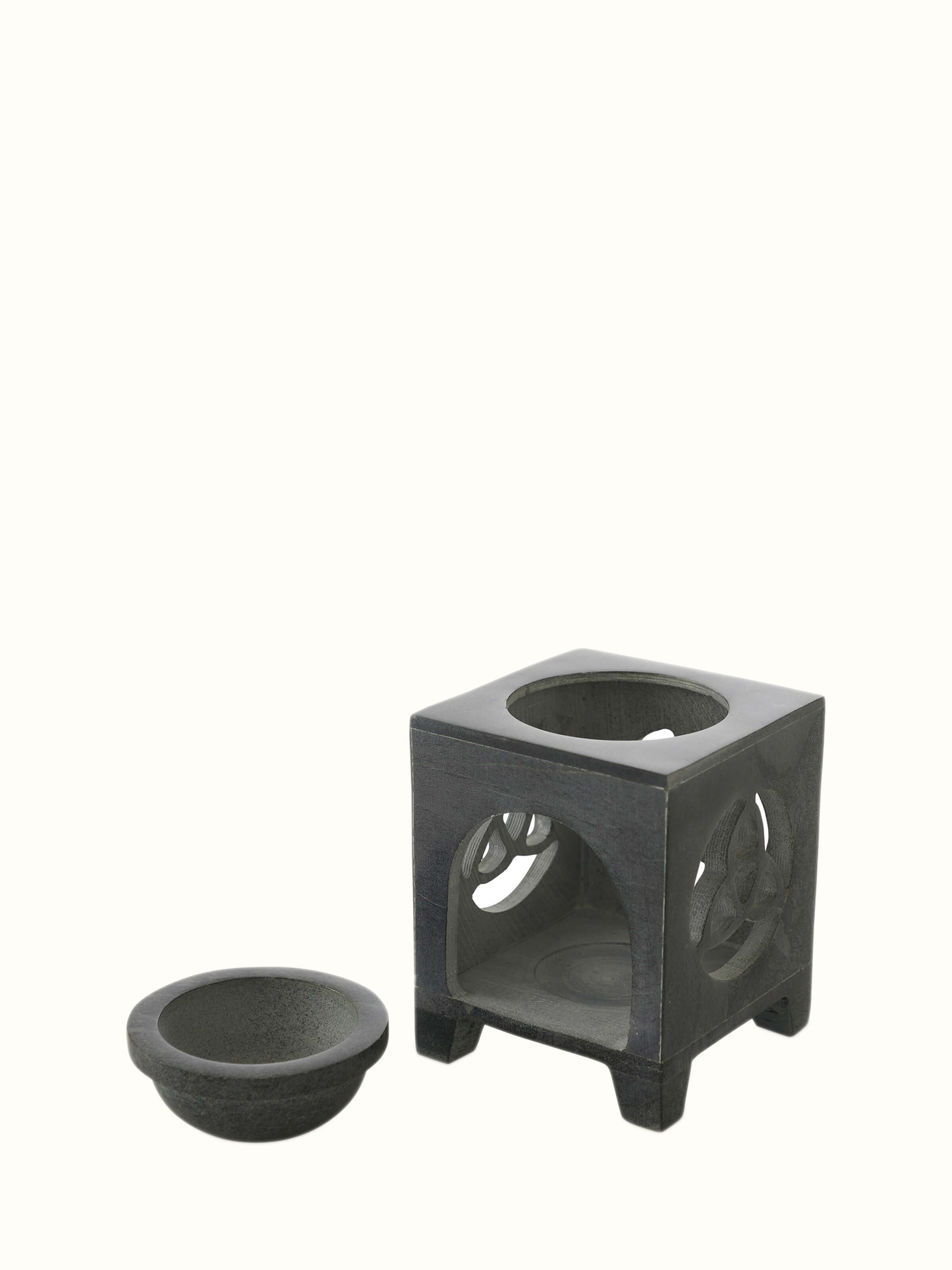 Side view of carved soapstone aroma oil burner & diffuser in black color highlighting the detailed carving and elegant shape