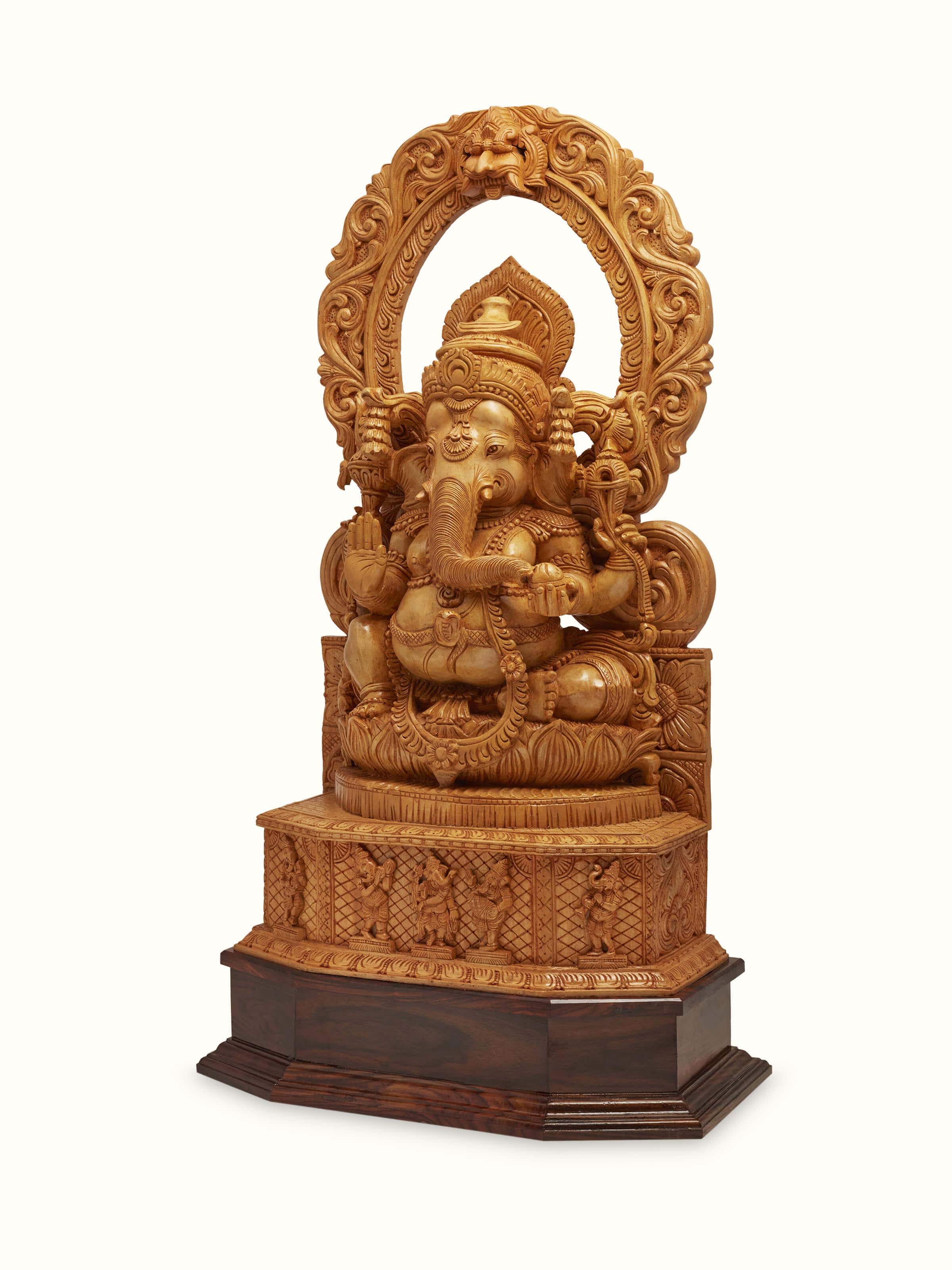 Side view of carved shivani wood Ganesha idol with prabhavali highlighting the intricate woodwork