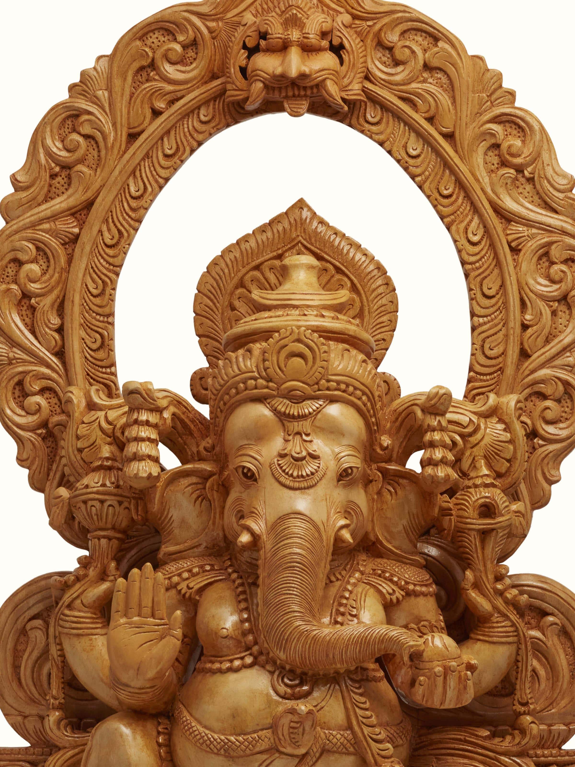 Angle view of carved shivani wood Ganesha idol with prabhavali emphasizing the elegant design