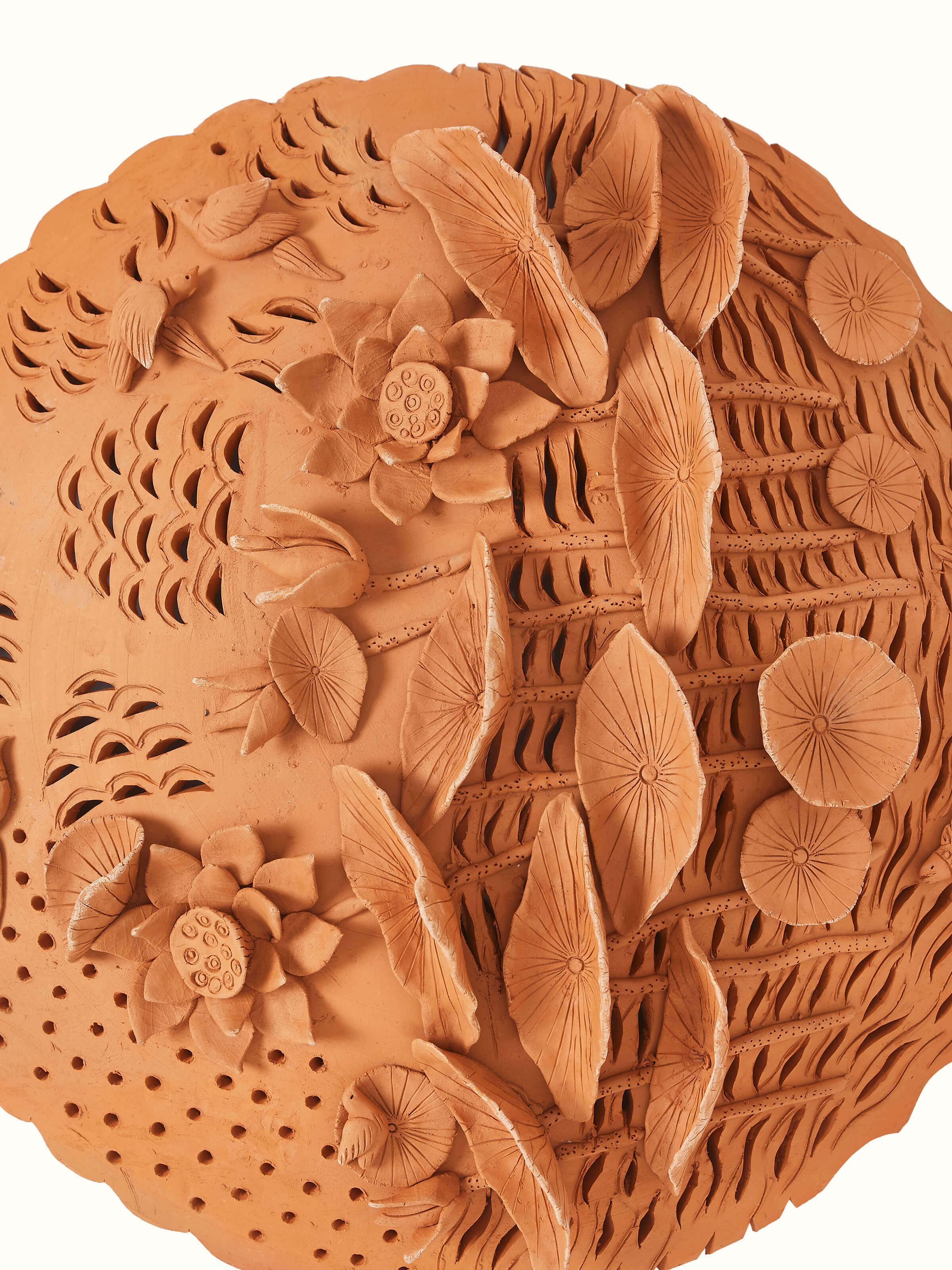 Detailed view of terracotta clay lotus cutout sculpture plate with elegant design