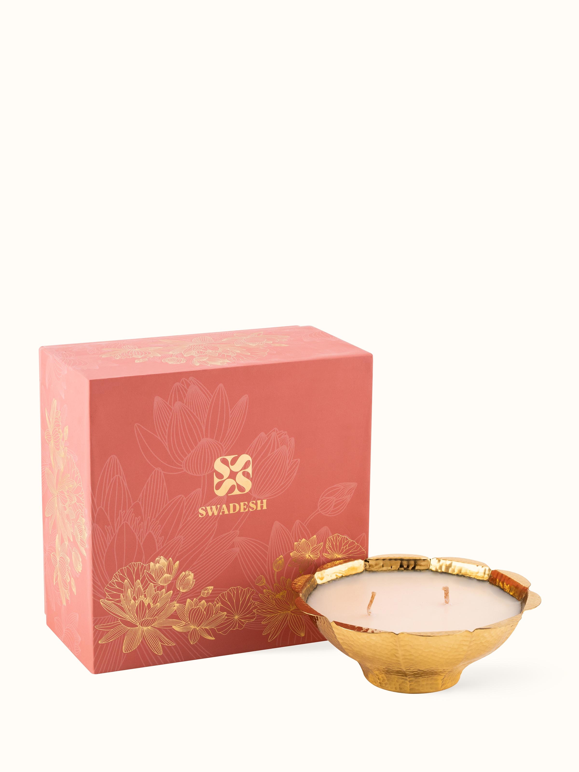 Detailed image of the brass candle with two wicks, focusing on its decorative elements.