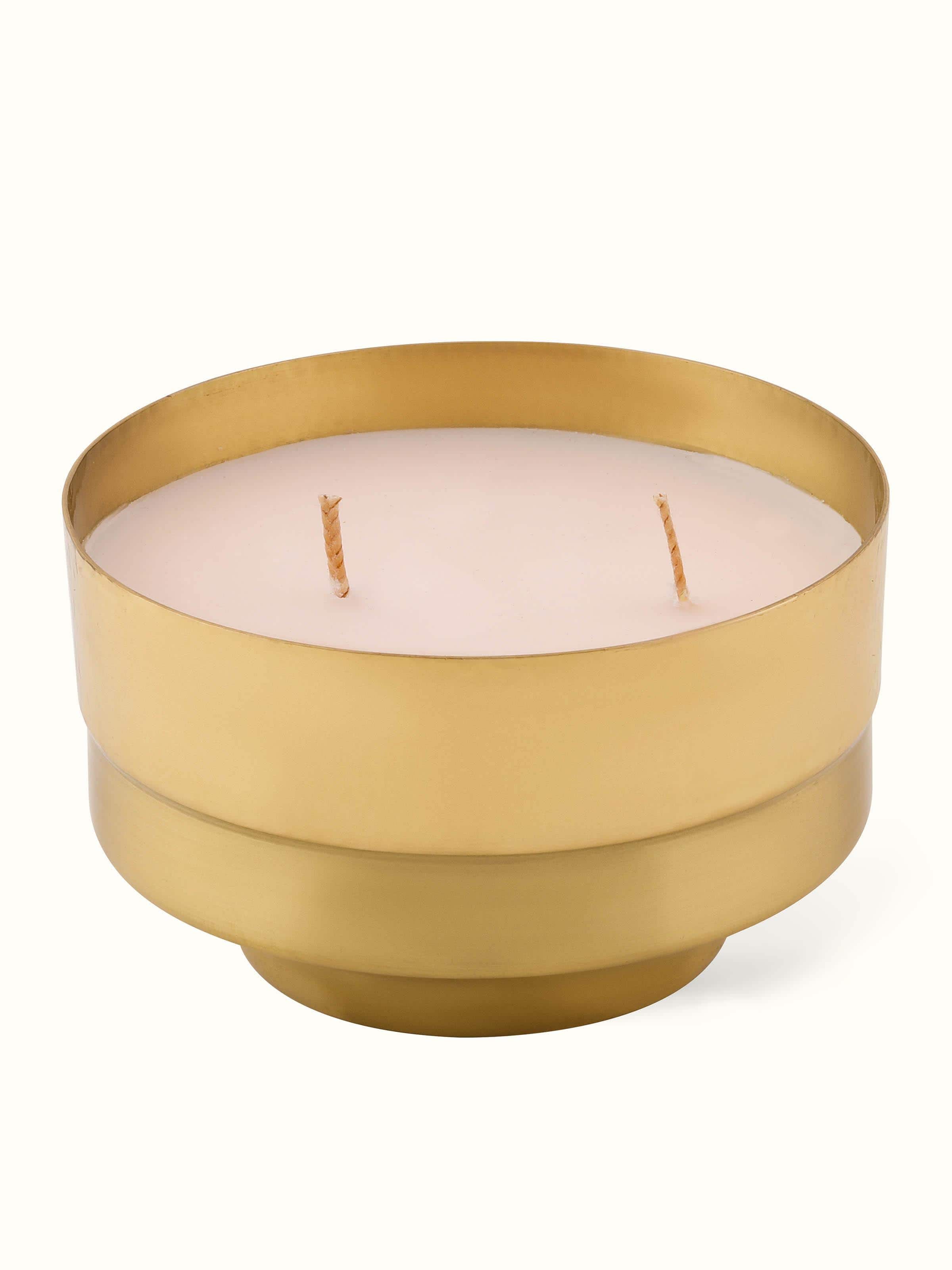 Neroli Brass Candle displayed on a reflective surface, enhancing its elegant design and aesthetic appeal