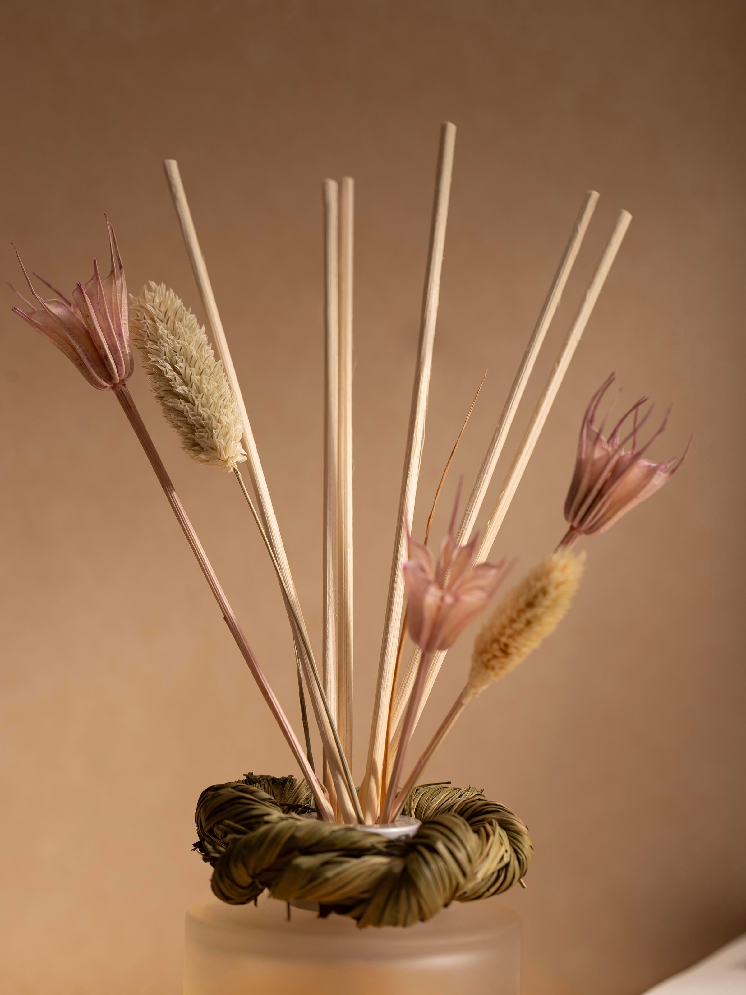 Side view of Lavender aroma reed diffuser bottle with reed sticks in the jar.