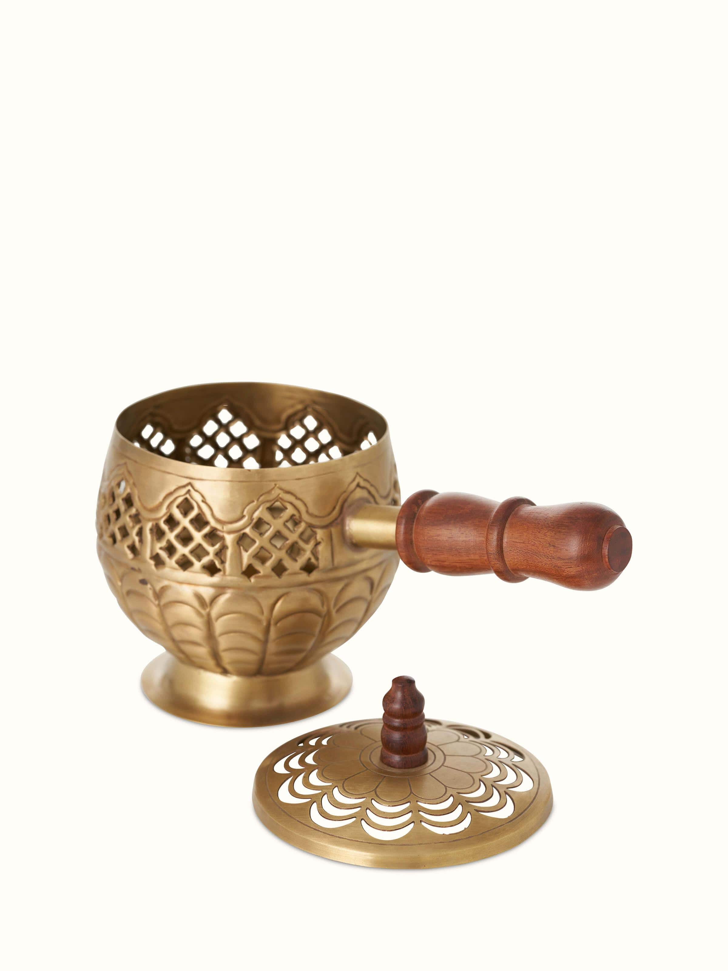 Close-up of Polished Brass Dhuna focusing on its intricate designs and lustrous brass surface.