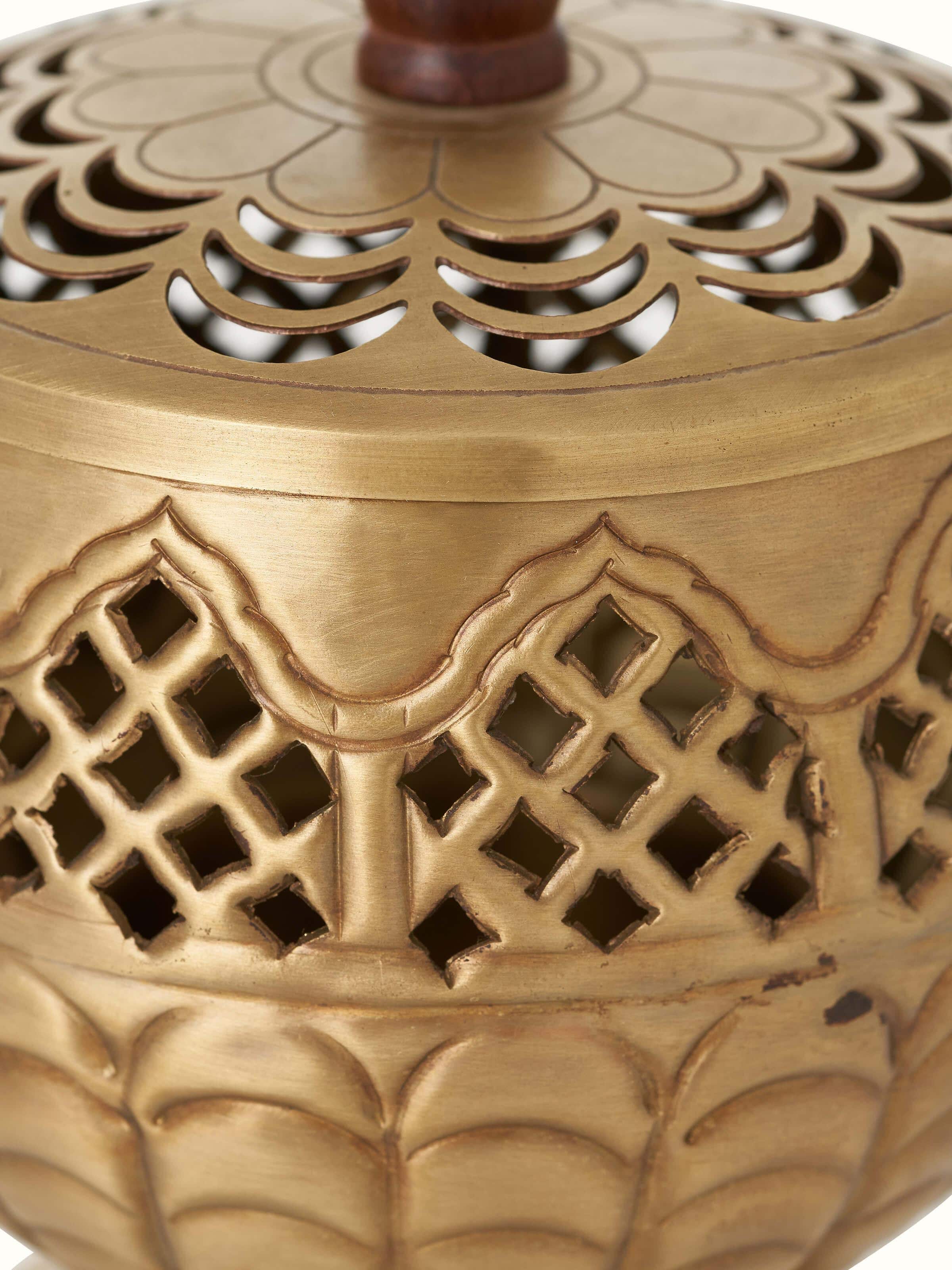 Zoom side view of Polished Brass Dhuna highlighting the fine metalwork and decorative elements.