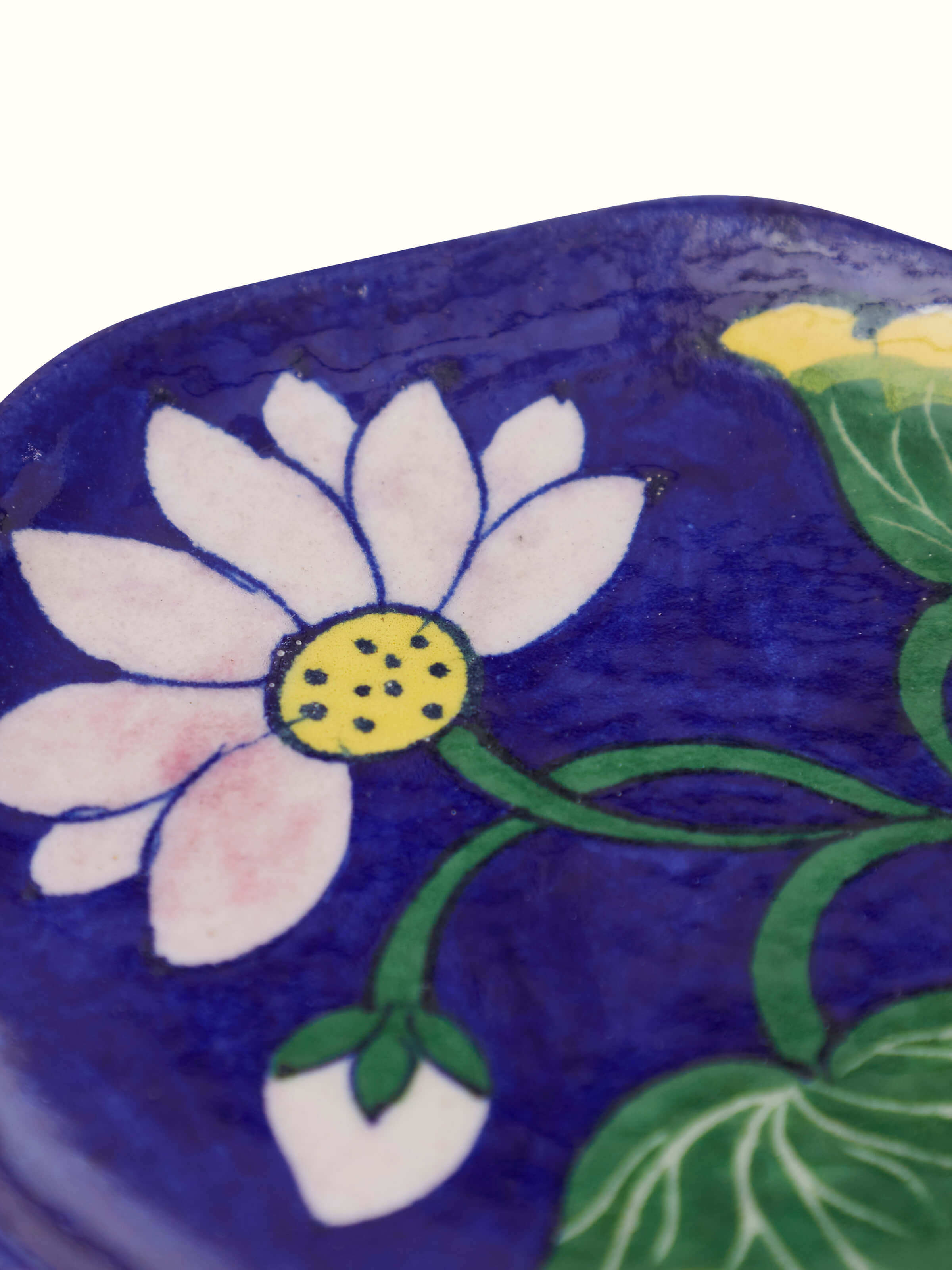 Close-up of blue pottery stoneware lotus incense stick holder focusing on intricate design and texture