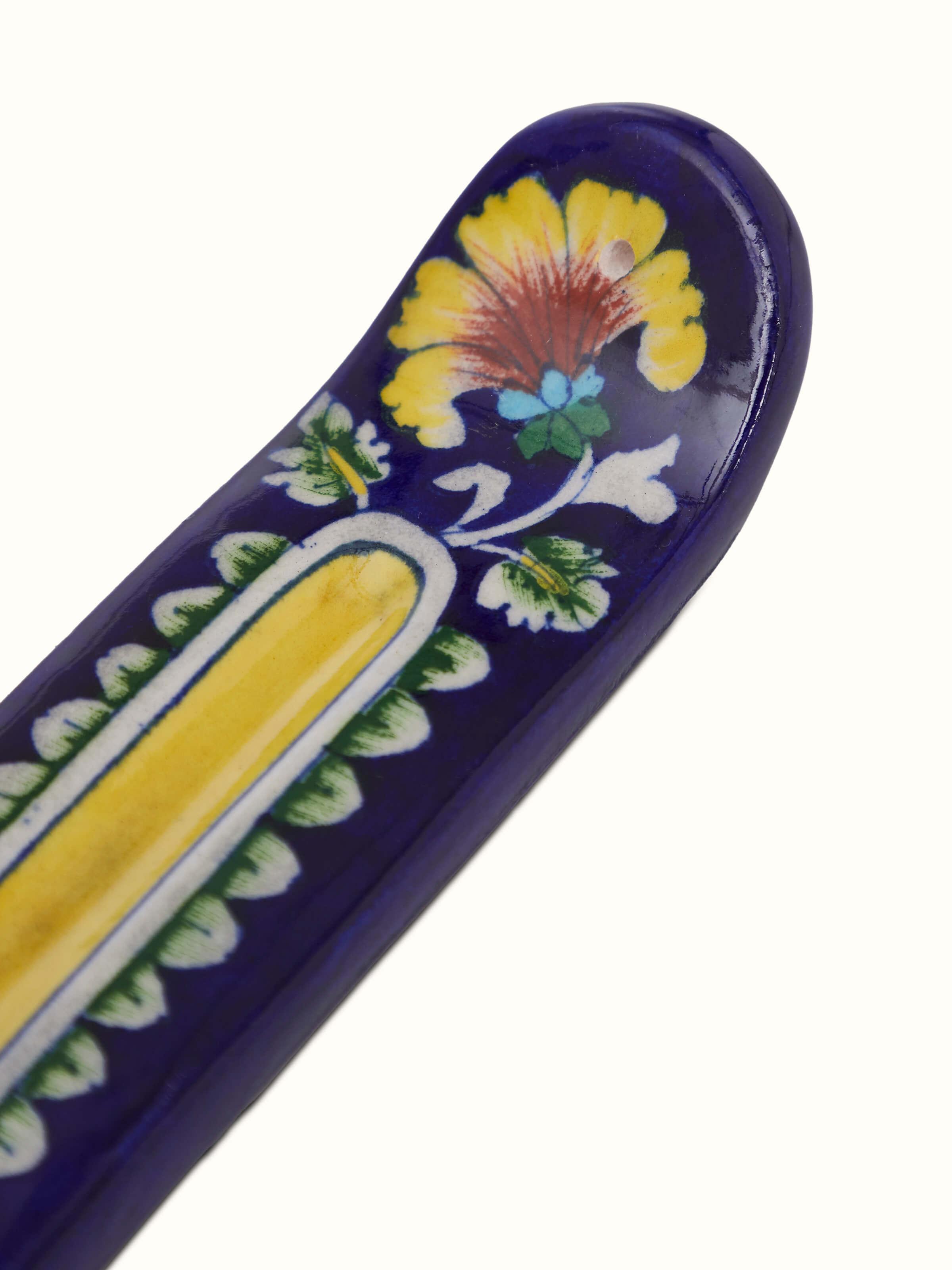 Close-up of blue pottery stoneware leaf incense holder highlighting the intricate leaf patterns and vibrant glaze.