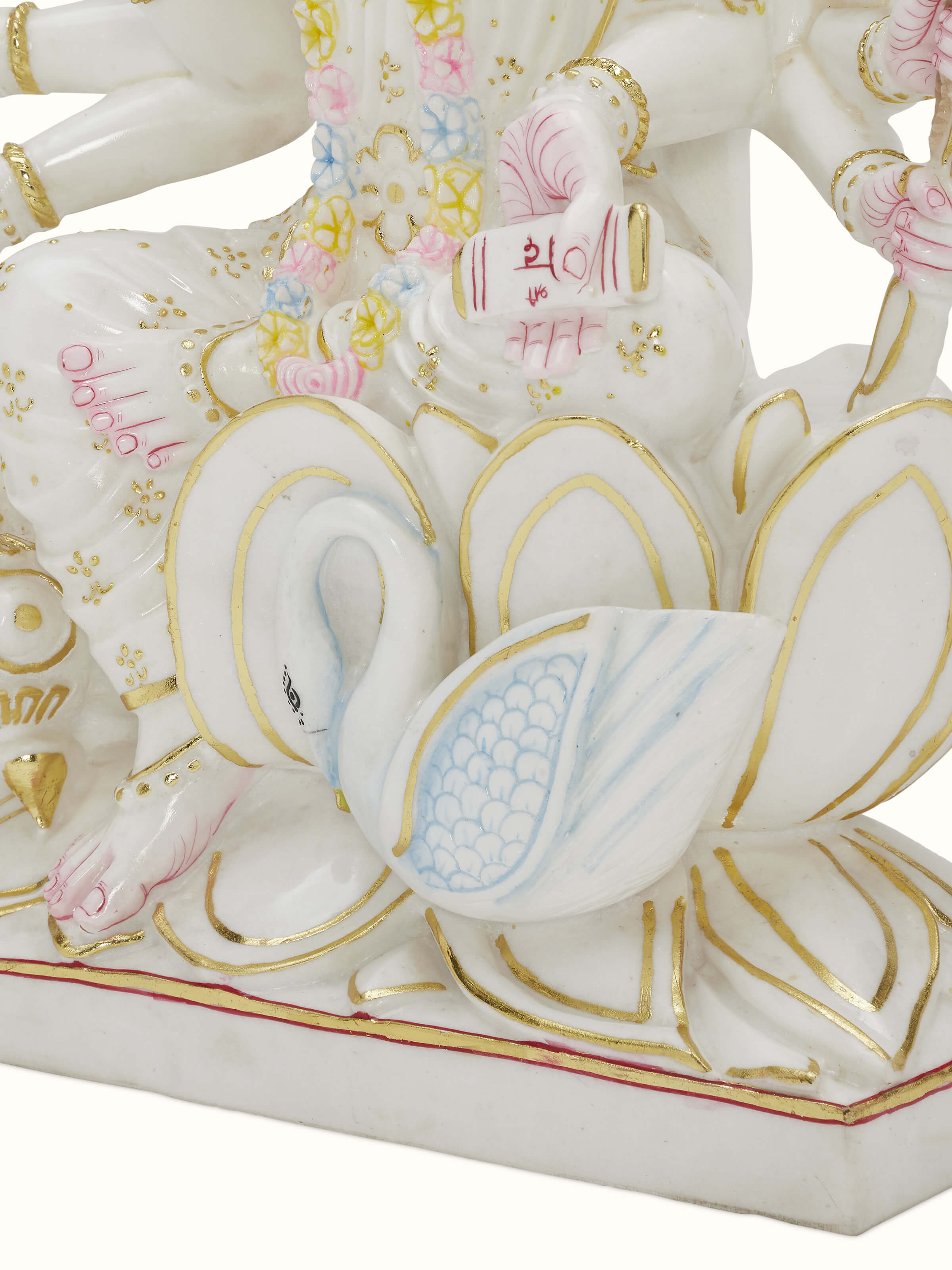 Close-up of Gayatri Mata Ji carved marble idol, showcasing the intricate carving and delicate features.