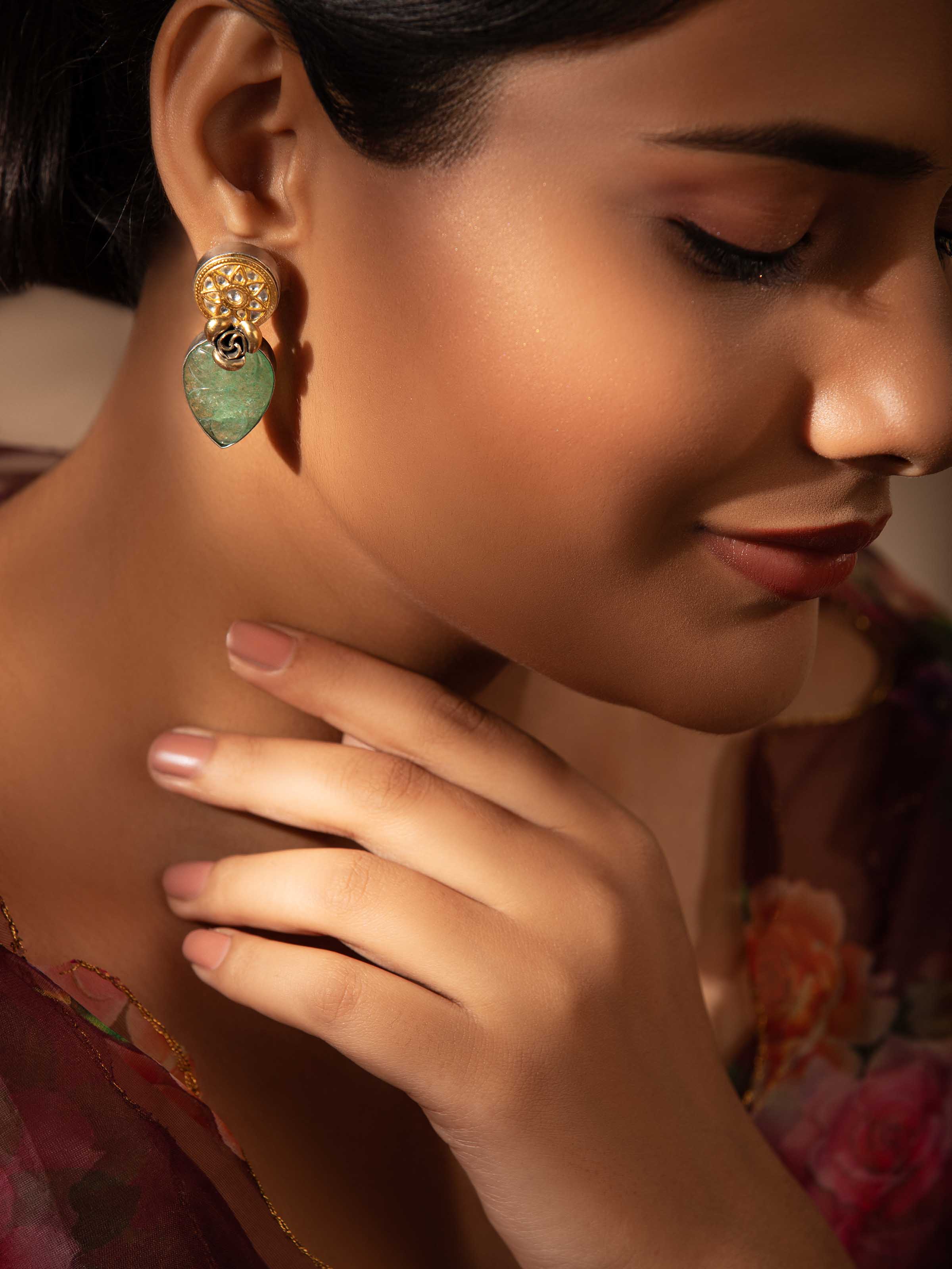 Close-up side view showing detailed design of silver drop earrings