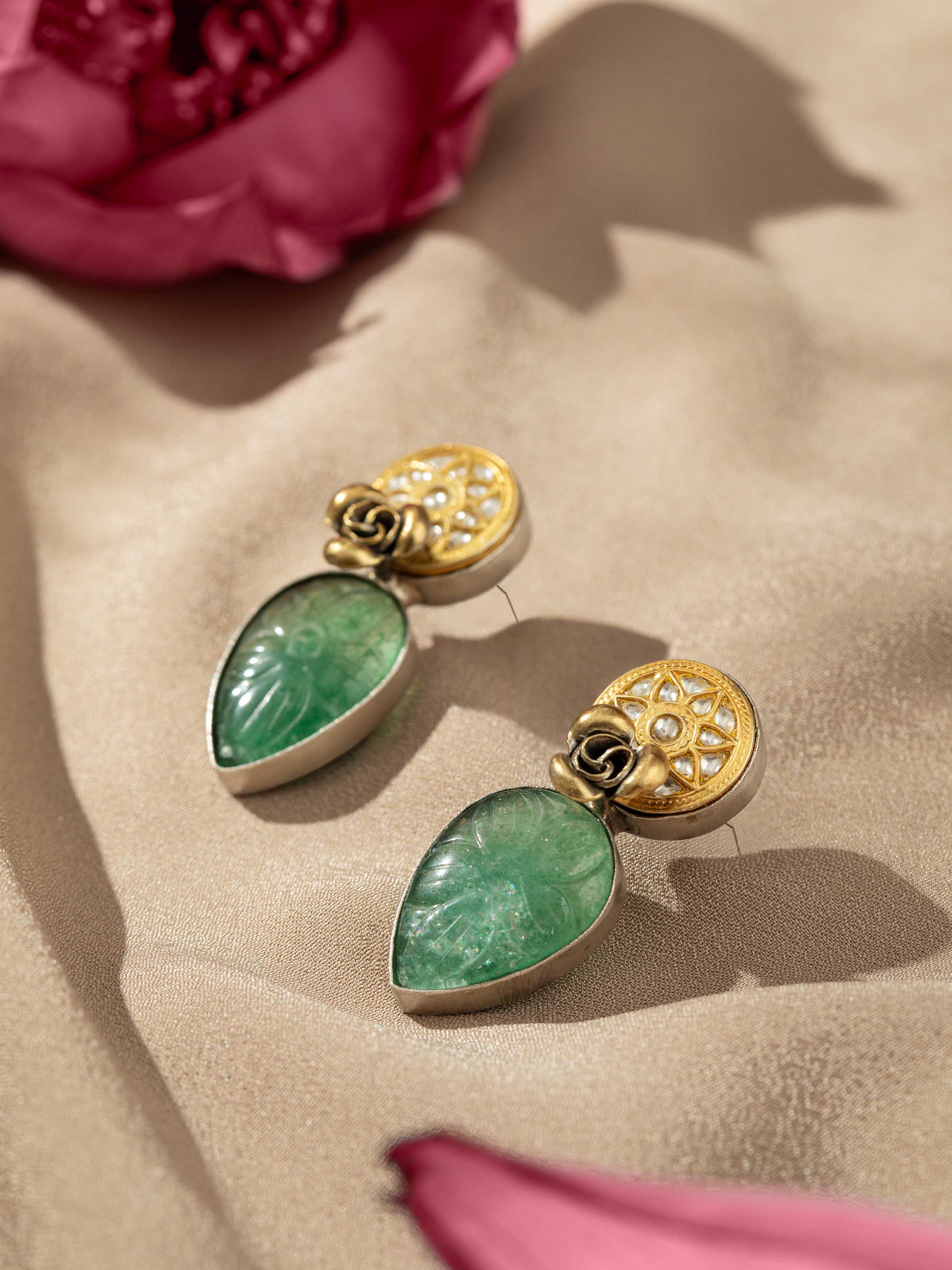 Detailed shot focusing on the chain and delicate silver smithing on drop earrings