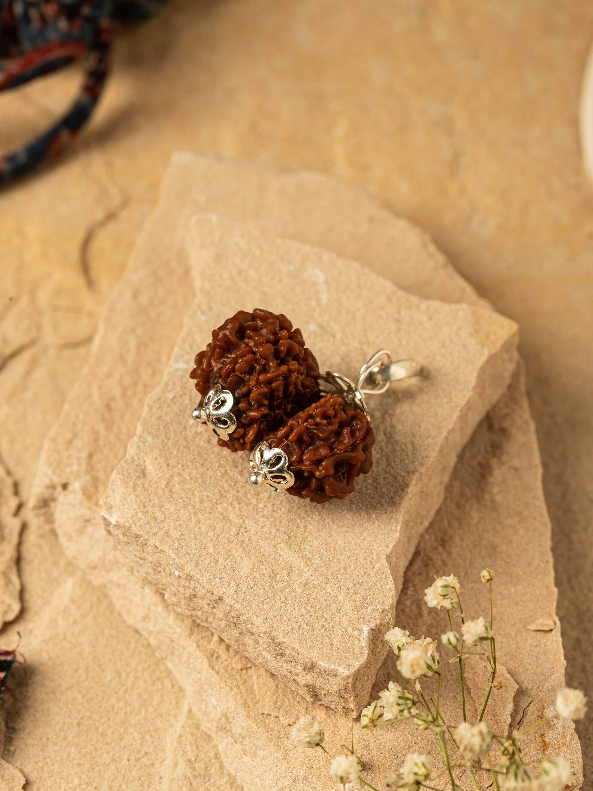 Side view of Gaurishankar Rudraksha Sterling Silver Pendant highlighting the pendant's profile.
