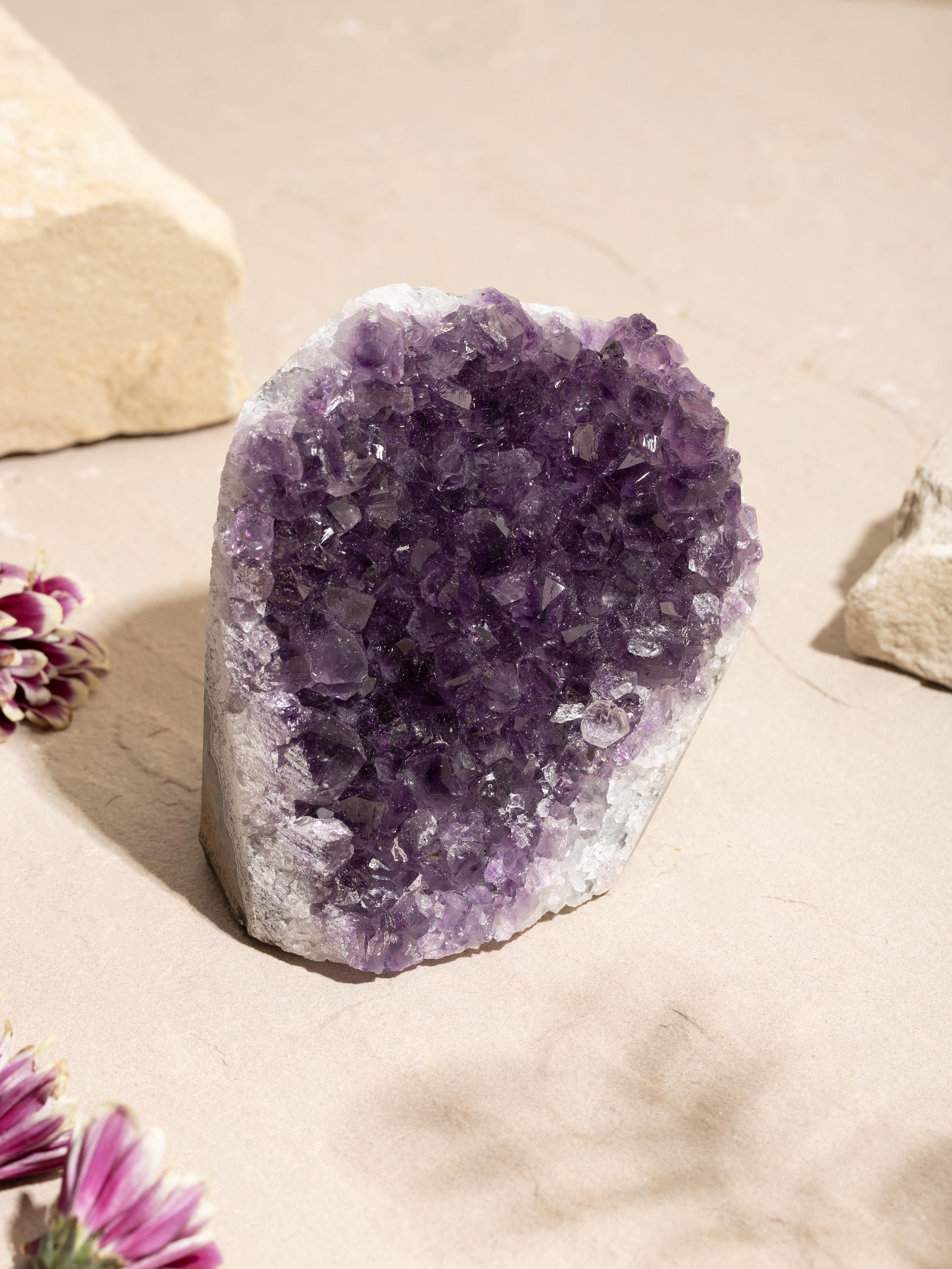 Side view of large Amethyst geode healing stone displaying its rich purple hues and unique texture