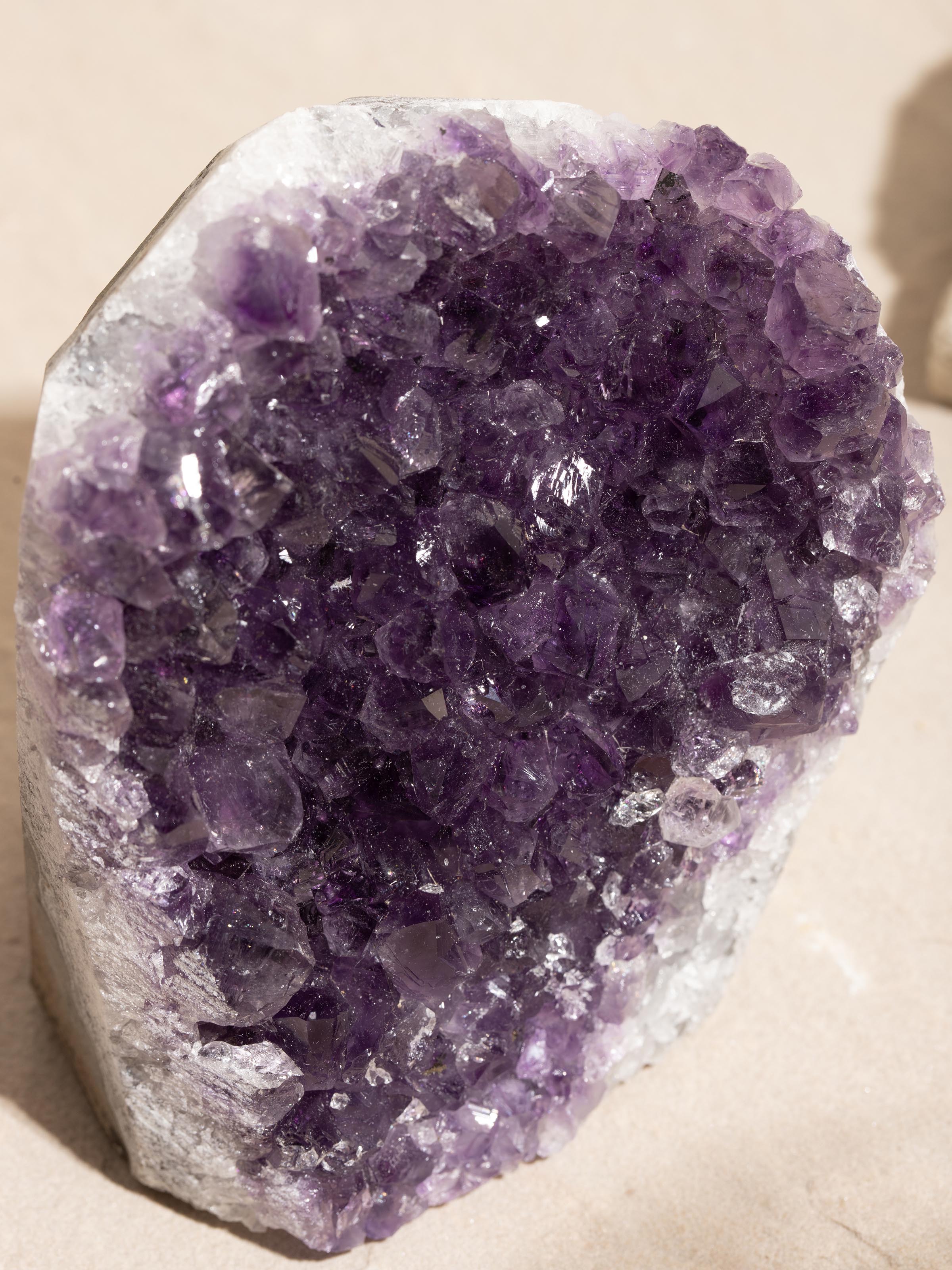 Detailed close-up of a large Amethyst geode healing stone, showcasing its sparkling crystal interior
