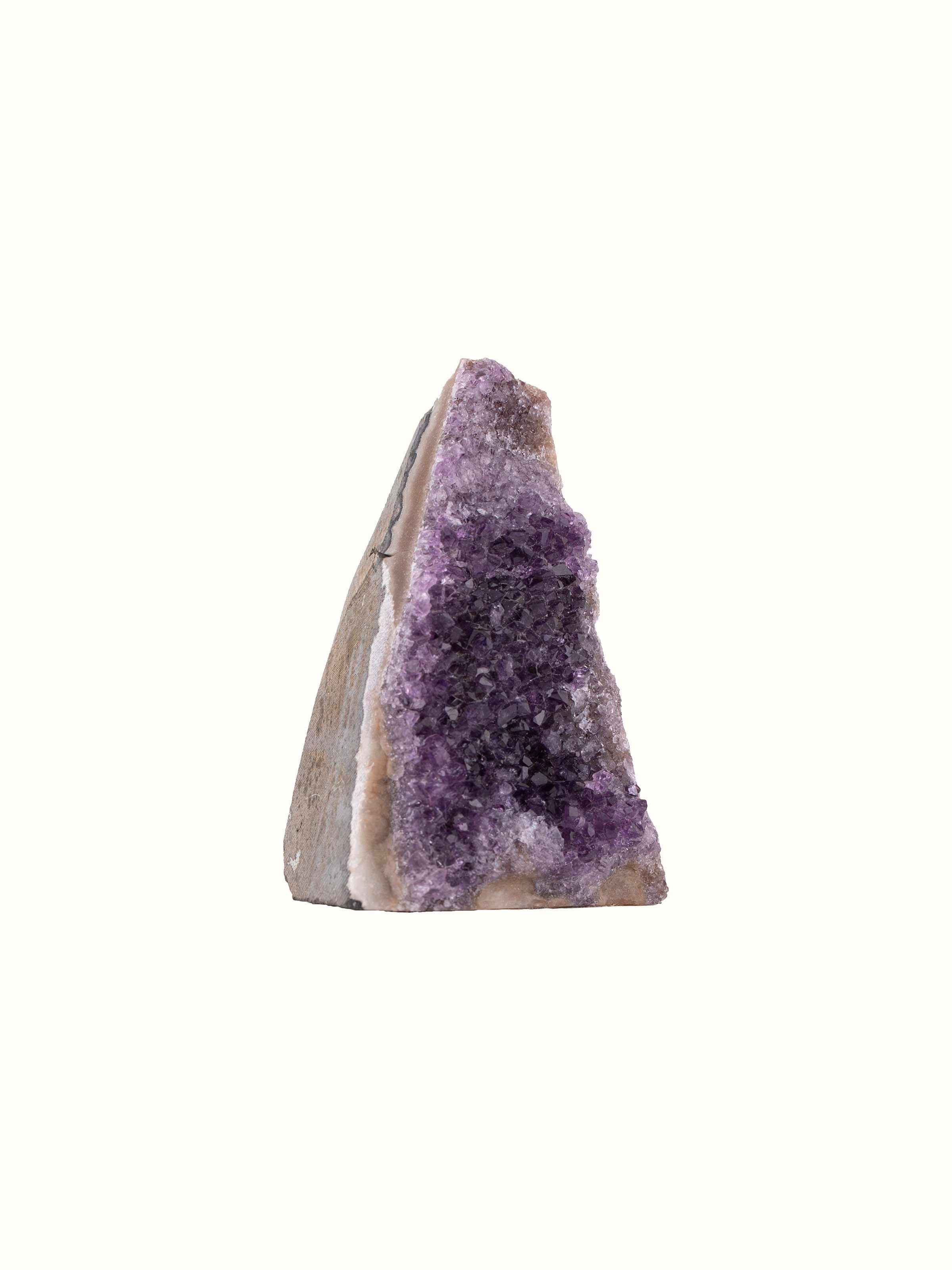 Side angle of Medium Amethyst Geode revealing the depth of crystal clusters and natural geode exterior