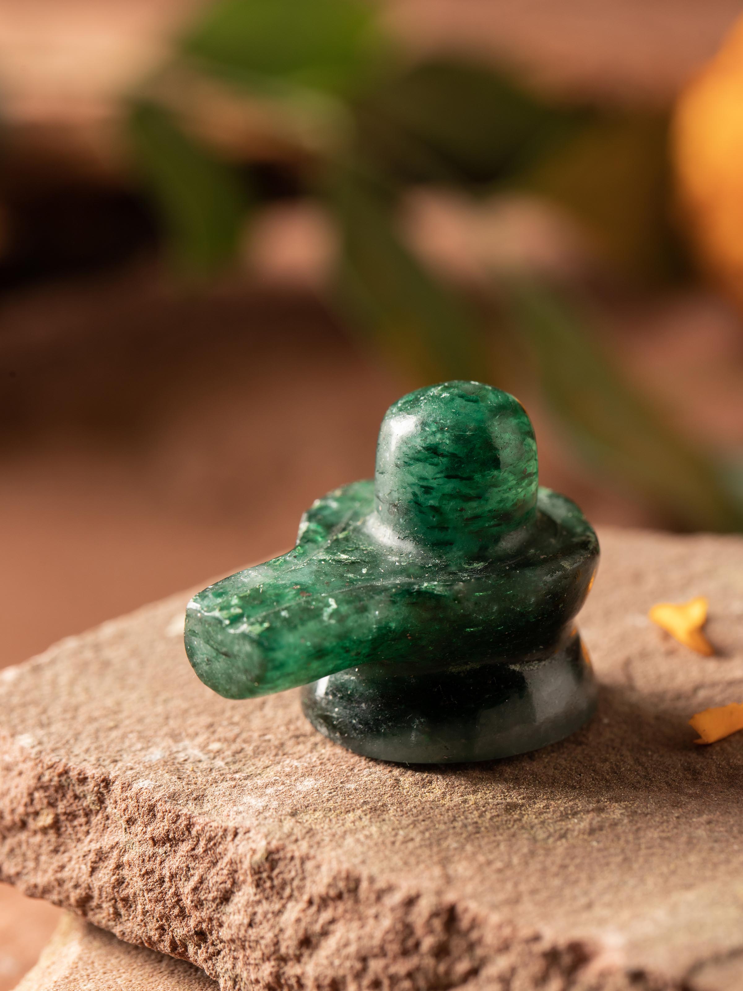 Side view of Swadesh Small Jade Shivling, showcasing its intricate design and natural jade texture.