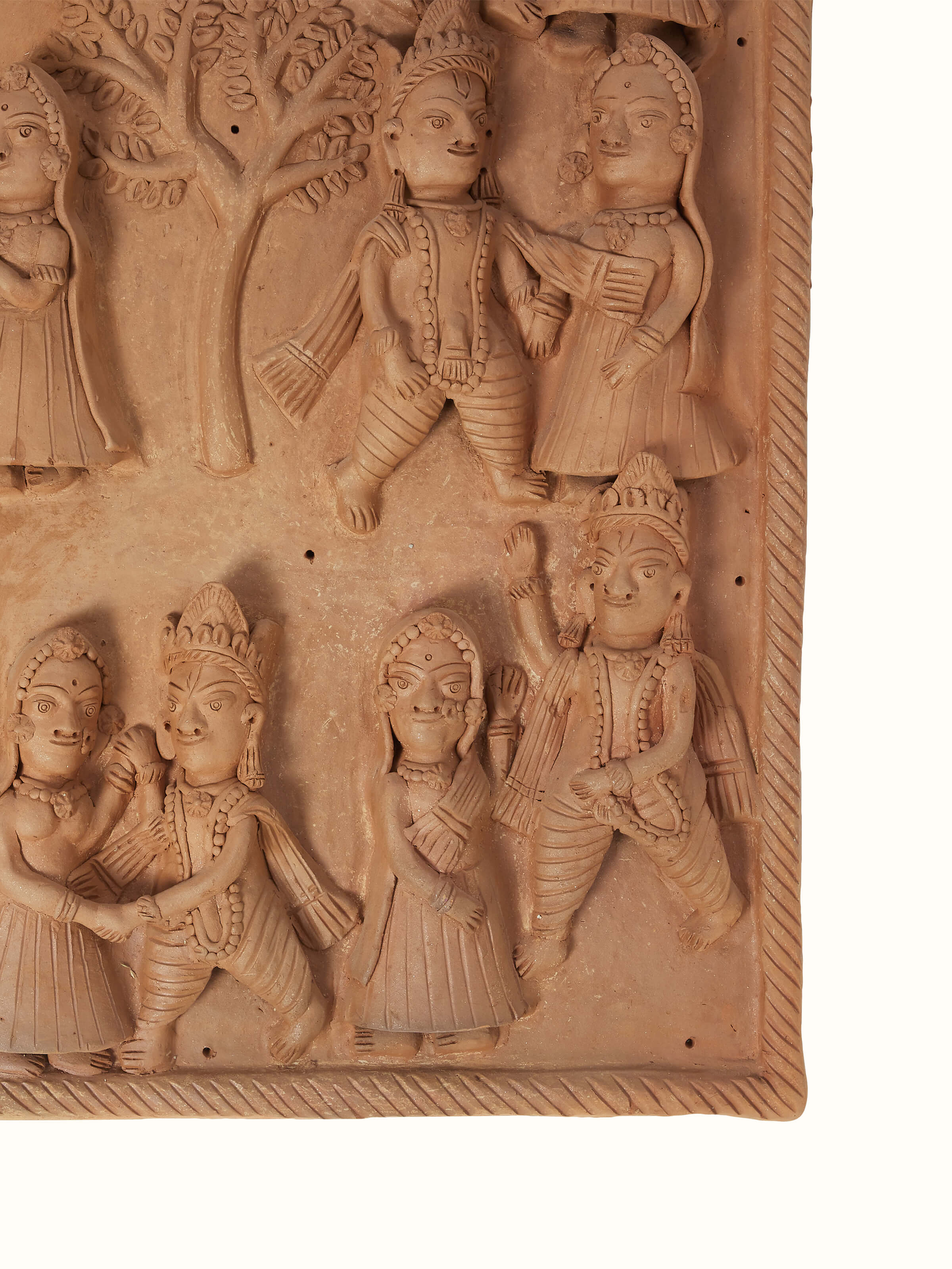 Side view of Terracotta clay Radha Krishna raas leela idol highlighting texture