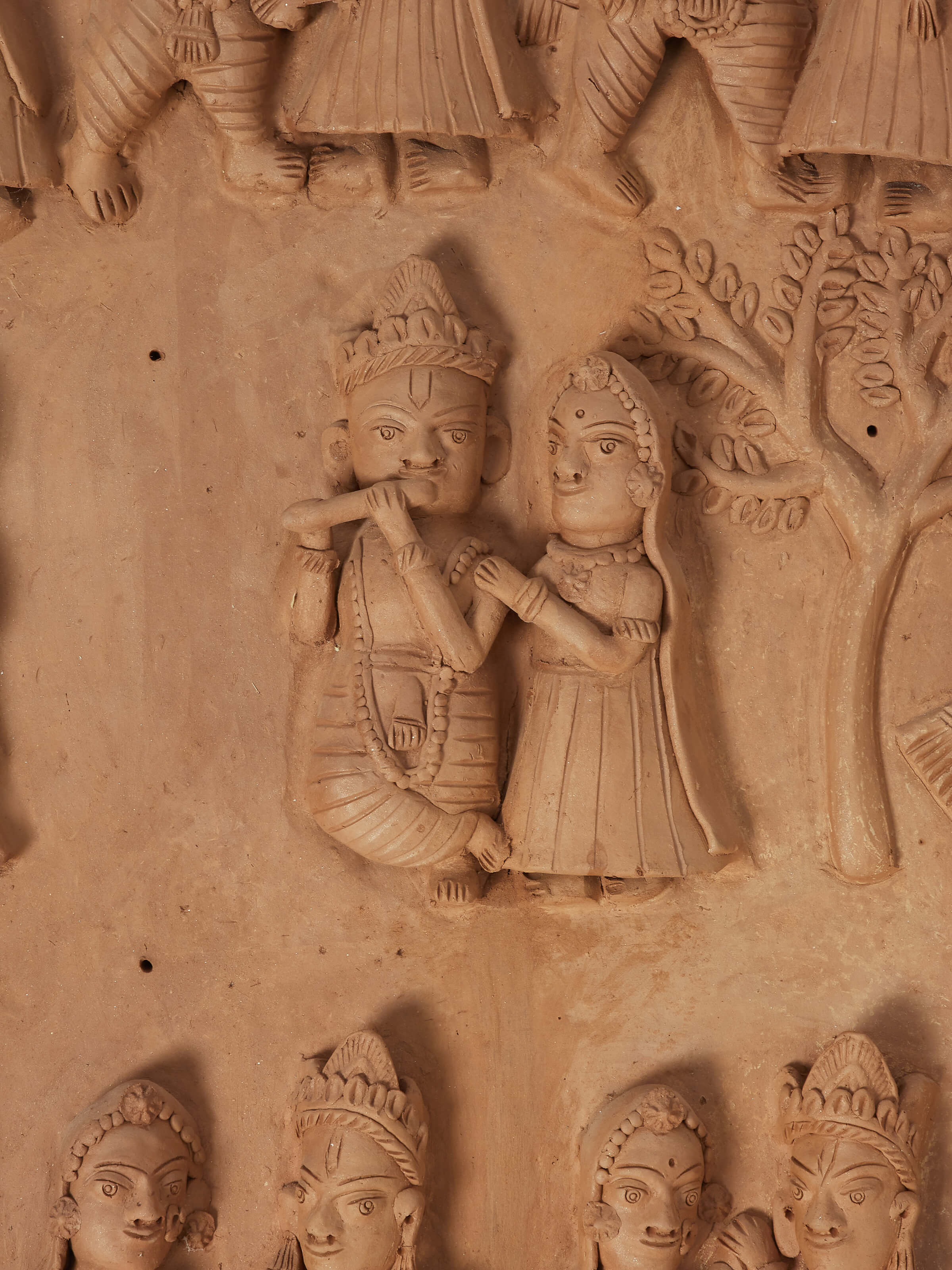 Detailed close-up of Terracotta clay Radha Krishna raas leela idol