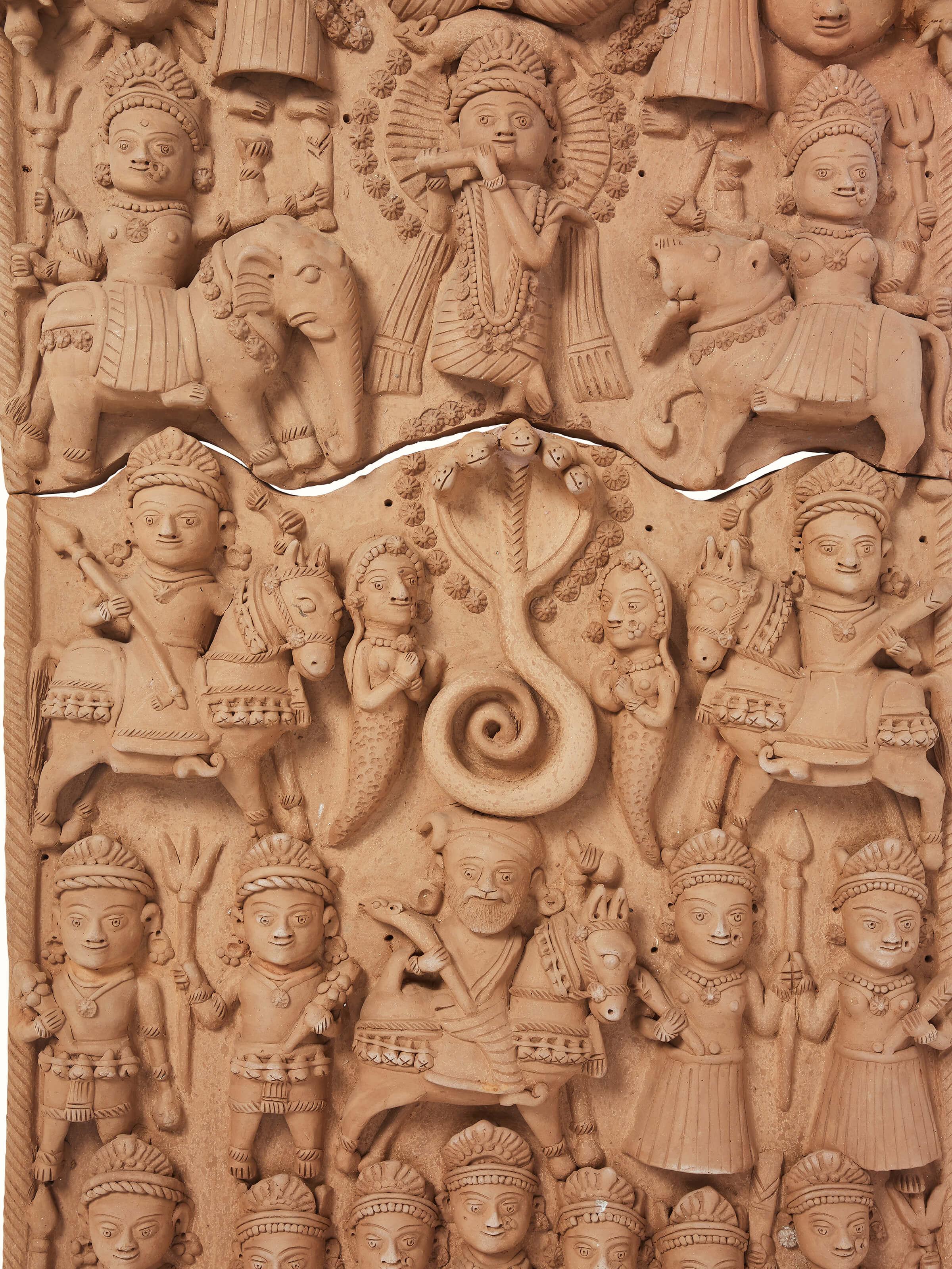 Close-up view of Terracotta clay Krishna story idol, showcasing the fine details and artistic expression