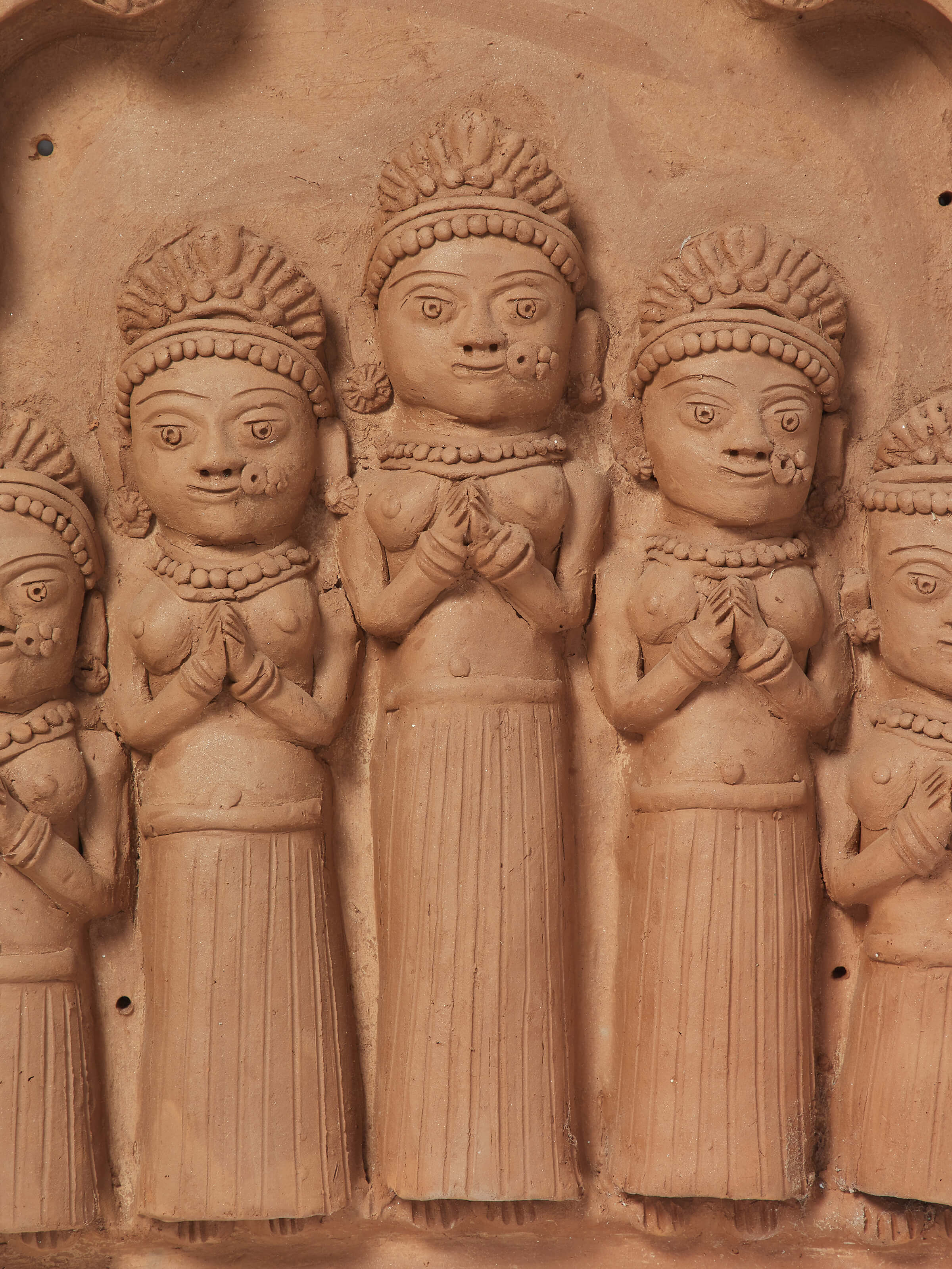 Side view of Terracotta clay five lords sculpture emphasizing the depth and detailing of the sculpture