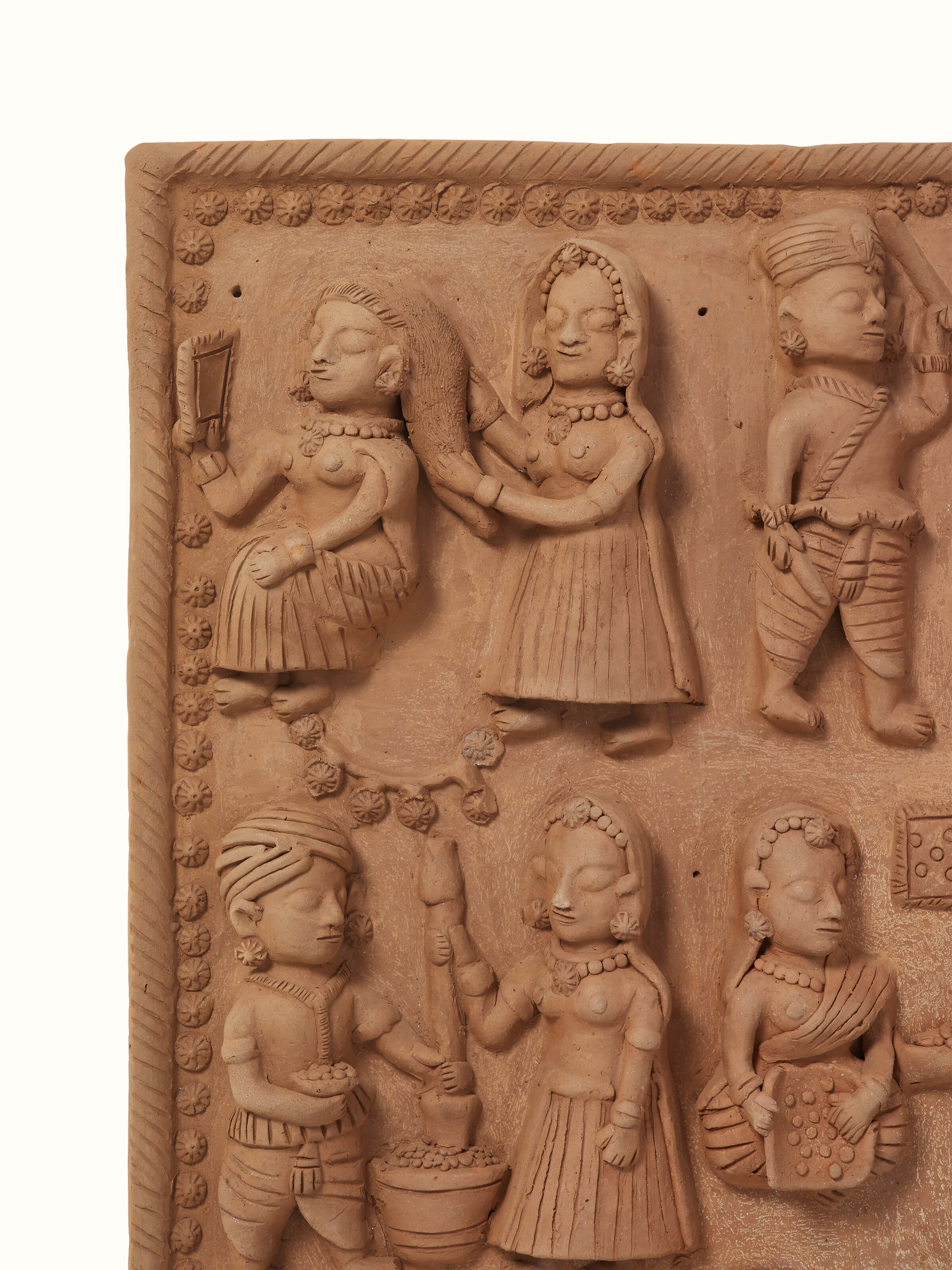 Side view of terracotta clay village scene sculpture revealing intricate detailing and artistry