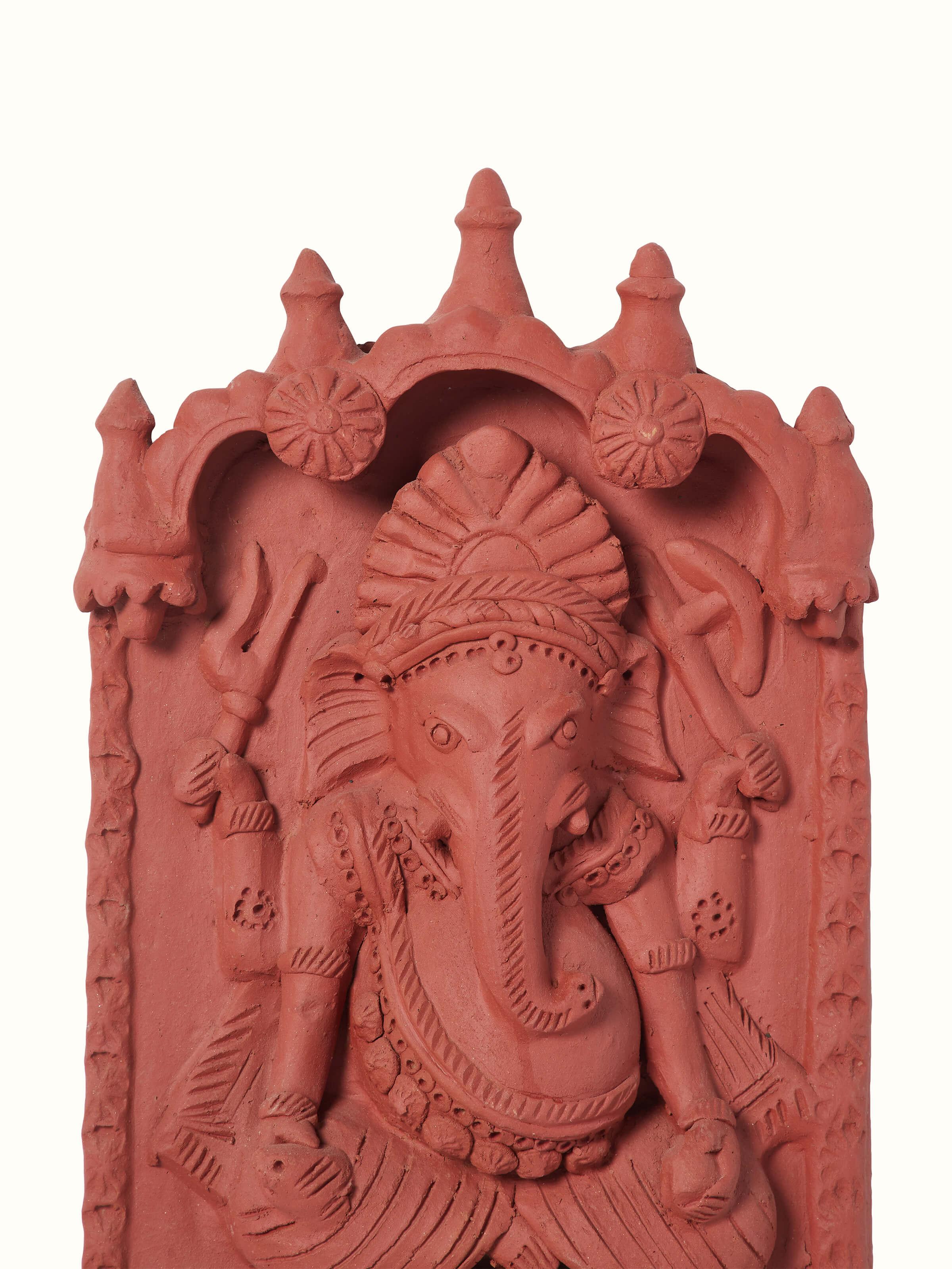 Side view of matte terracotta clay Ganesha idol, showcasing the detailed craftsmanship and artistic design.