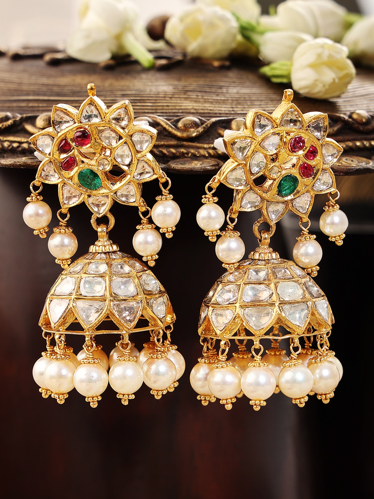 Angled view of Hyderabad Jadau 22 karat gold drop earrings showcasing their luxurious design