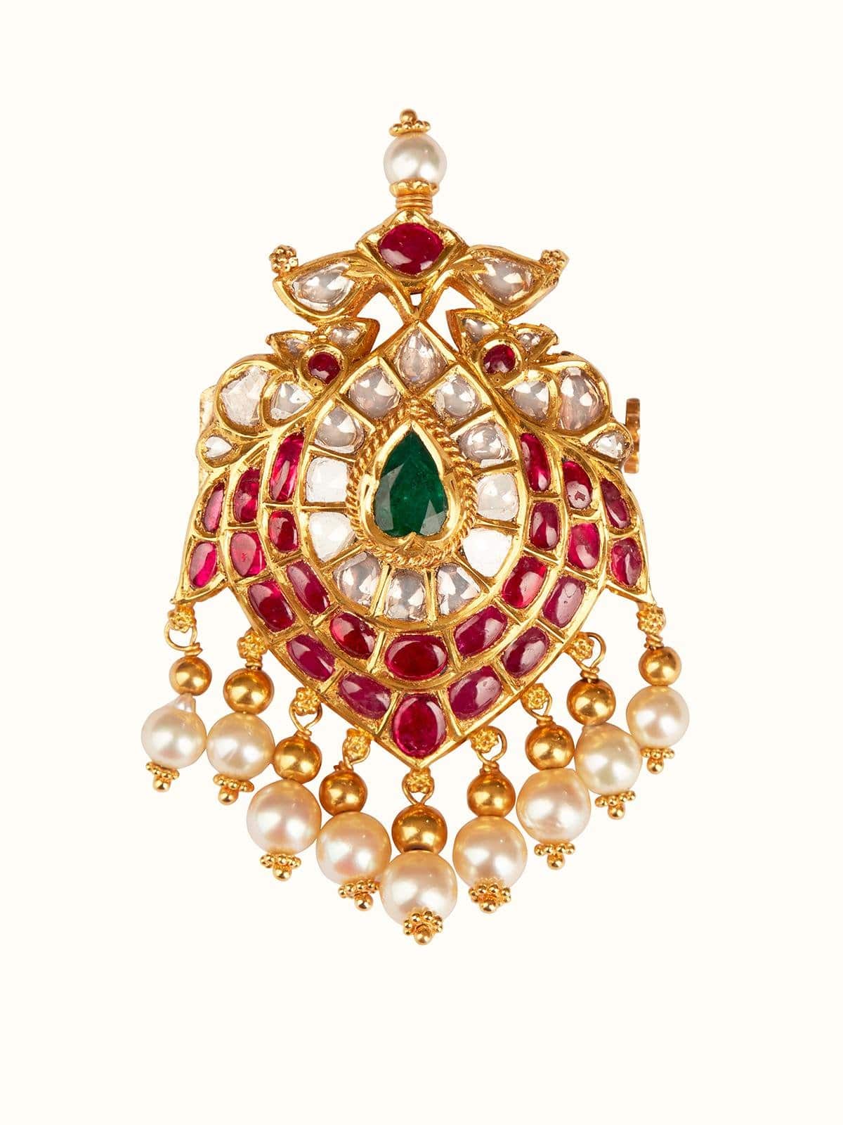 Front view of Jamila Jadau 18 karat gold brooch pin showcasing regal design and intricate gemstone setting