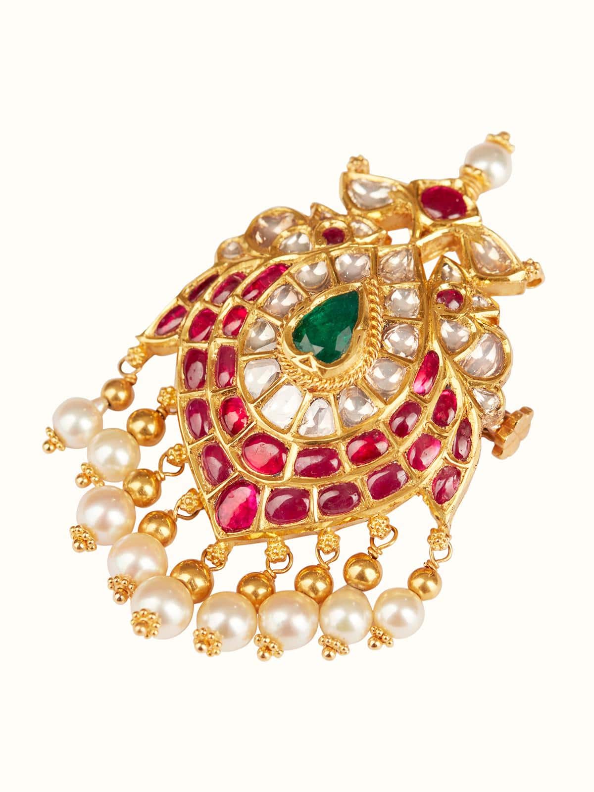 Angled view of Jadau brooch pin highlighting traditional craftsmanship and vibrant gem accents