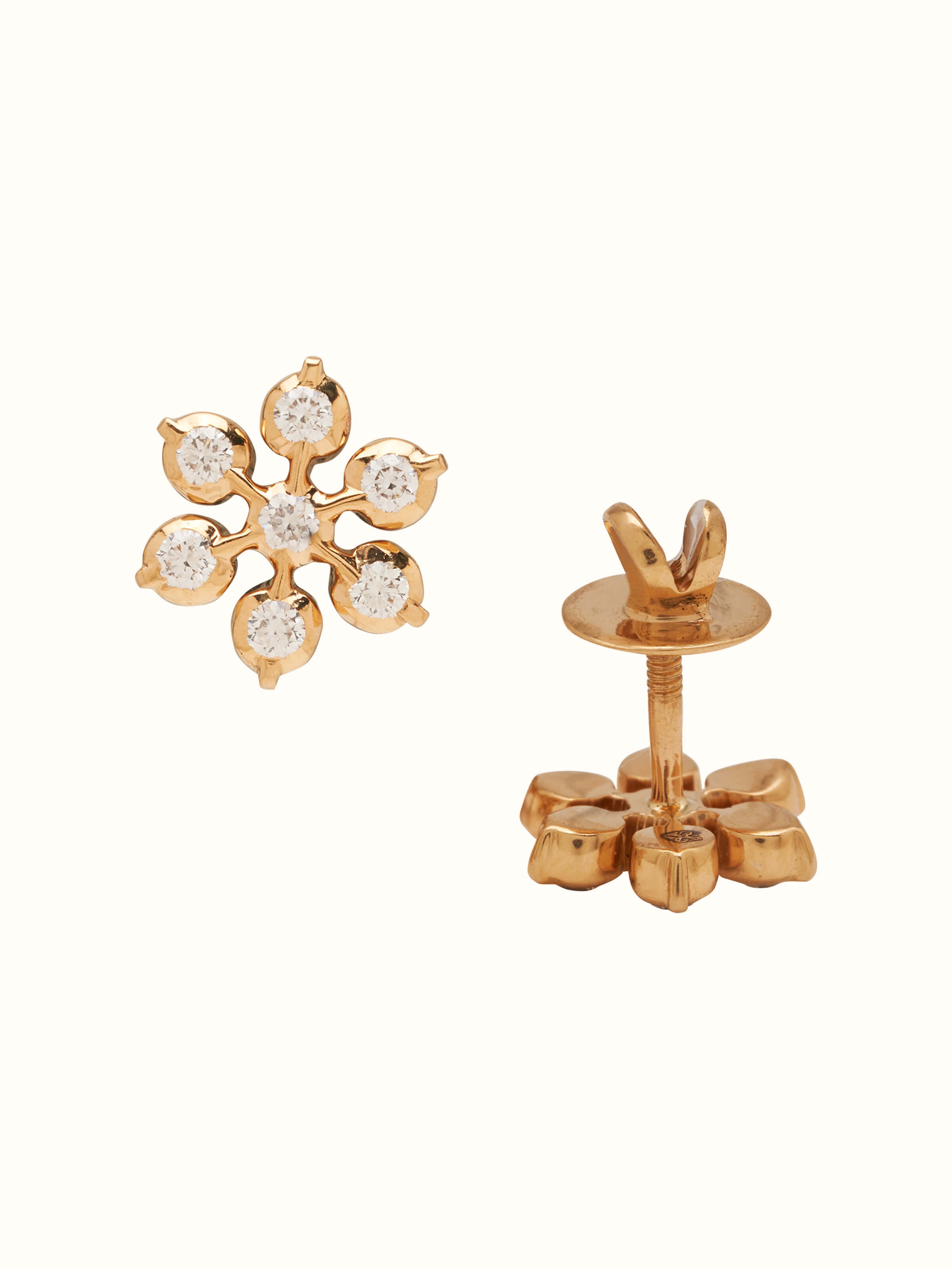 Angled view of close-setting 22 karat gold studs displaying secure design and polished finish