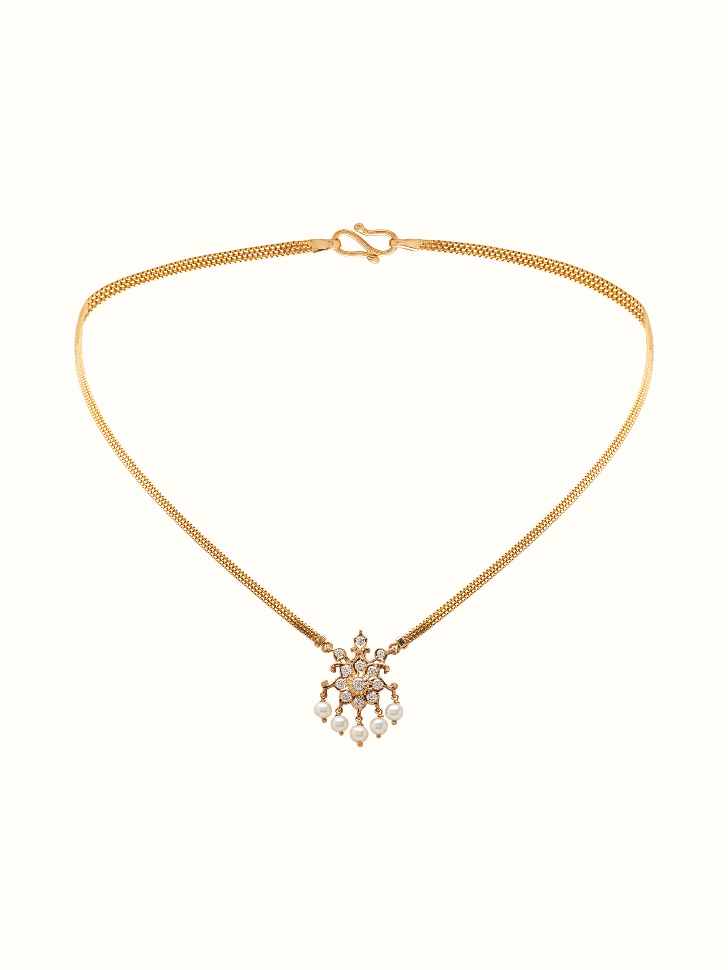 Front view showcasing the intricate pendant design with gold chain
